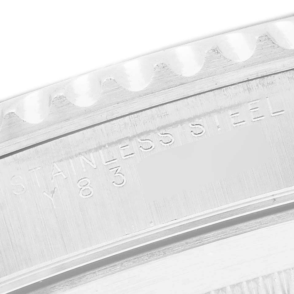 The image shows a close-up of the stainless steel case back of a Rolex Submariner 14060 Men's Stainless Steel Black Dial, highlighting the engraved text and edge.