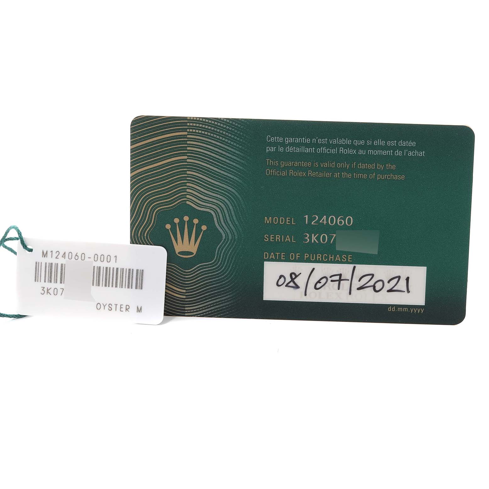 The image shows a guarantee card and a tag for the Rolex Submariner 124060 Men
s Stainless Steel Black Dial 124060 Men
s Stainless Steel Black Dial model 124060 with the serial number 3K07.