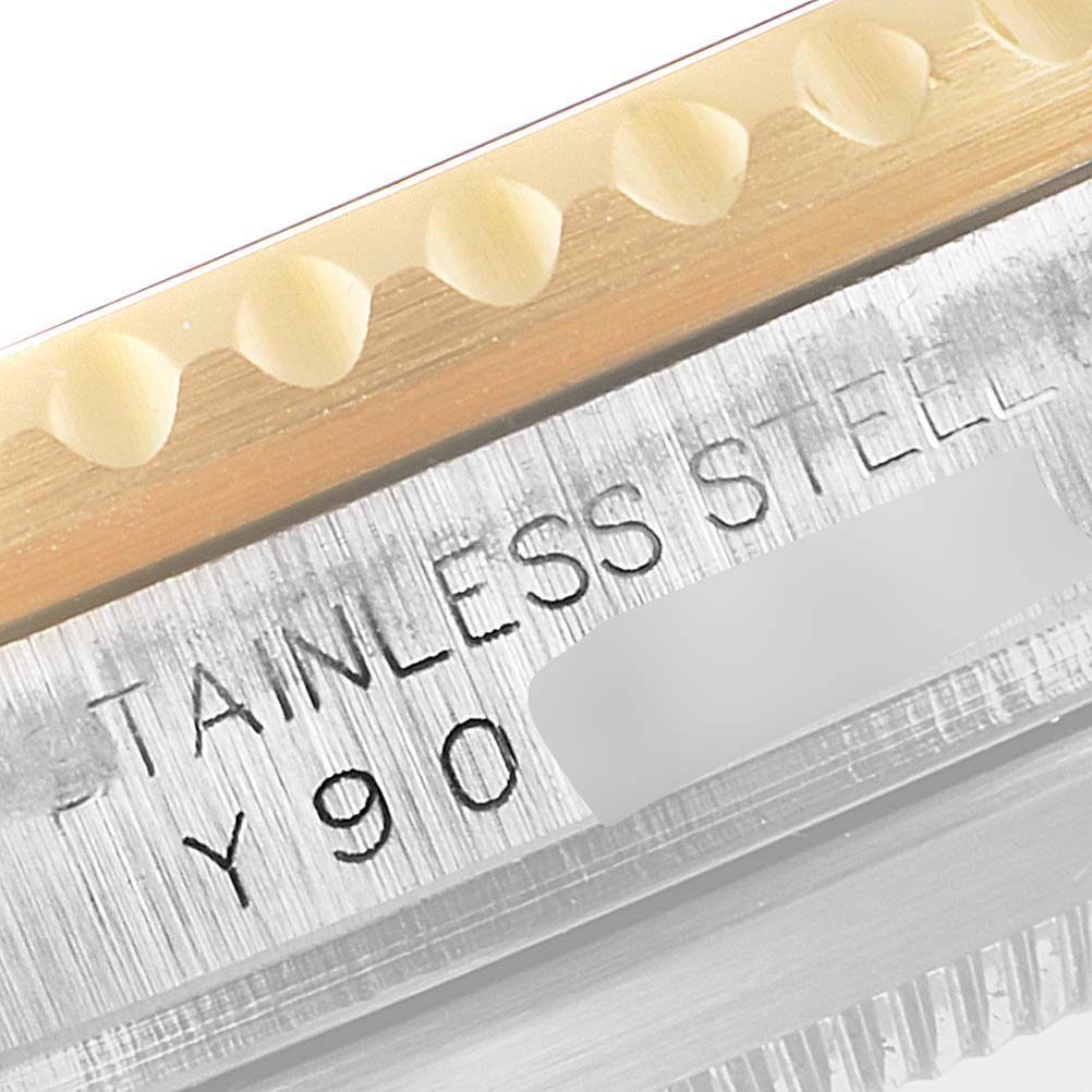 The image shows a close-up view of the stainless steel and gold edge of the bezel with a partial serial number of a Rolex Submariner 16613 Men's Steel and Gold (two tone) Champagne Dial 16613 Men's Steel and Gold (two tone) Champagne Dial watch.