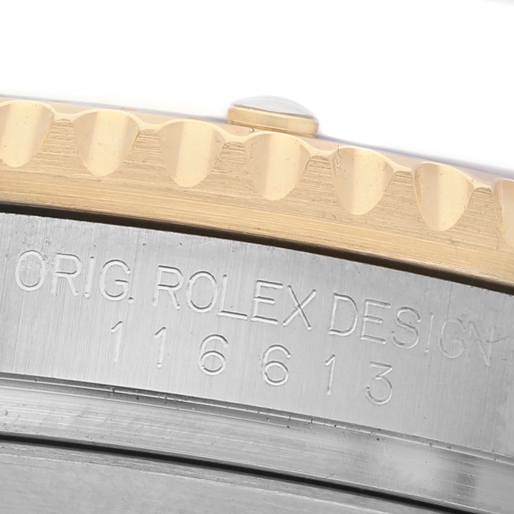 The image shows a close-up of the side of a Rolex Submariner 116613 Men's Steel and Gold (two tone) Blue Dial, focusing on the engraved case and part of the bezel.