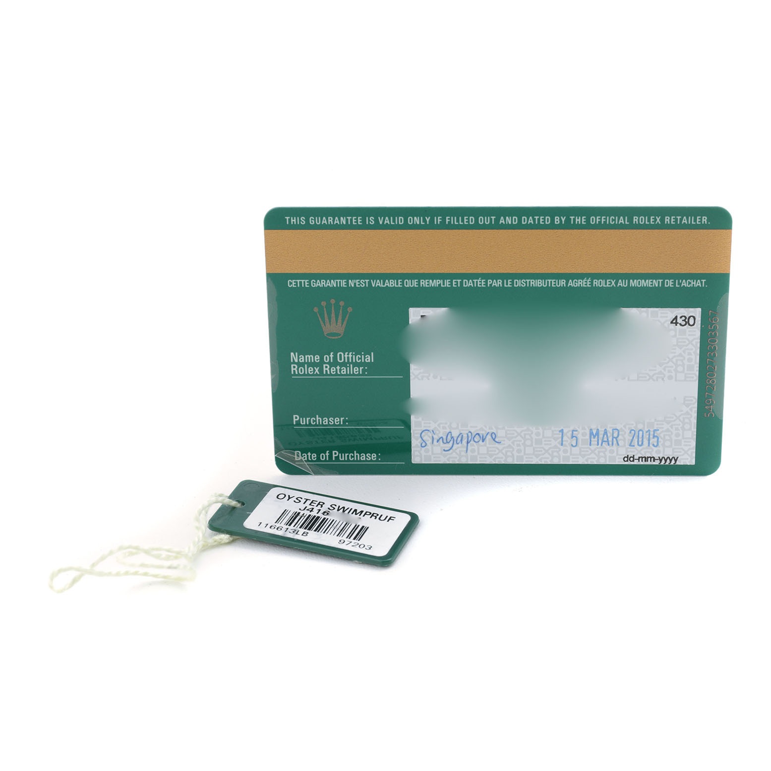 The image shows a warranty card and hang tag for the Rolex Submariner 116613 Men's Steel and Gold (two tone) Blue Dial, viewed from above.
