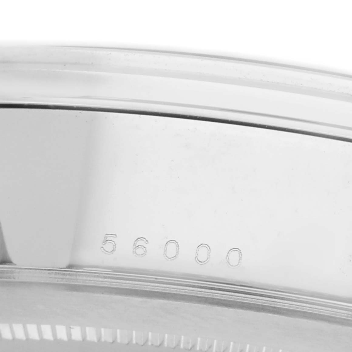 The image shows a close-up of the side of a Tudor Glamour 56000 Men's Stainless Steel Black Dial model, highlighting the case edge and engraving.
