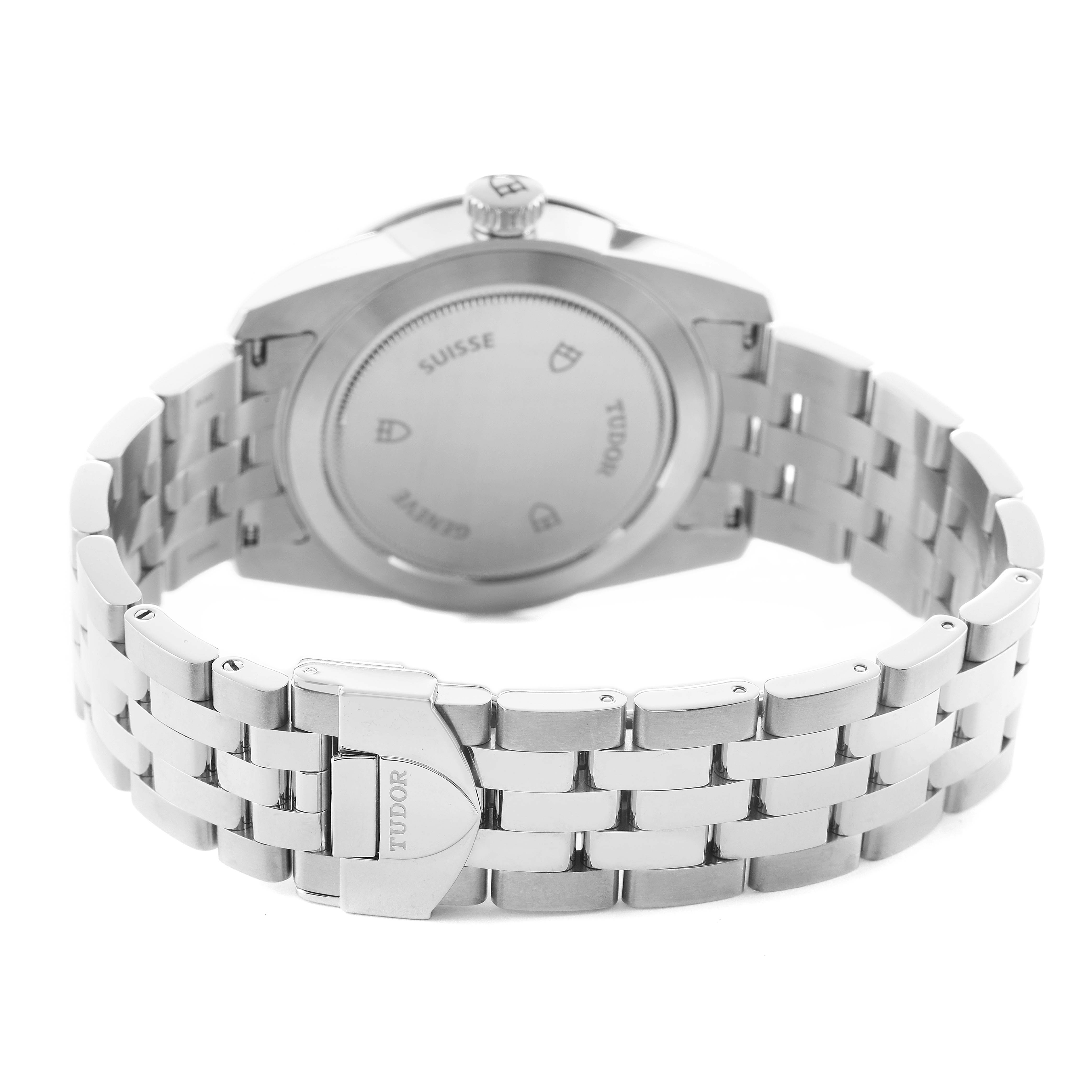 The image shows the back view of a Tudor Glamour 56000 Men's Stainless Steel Black Dial watch, focusing on the stainless steel bracelet and clasp.