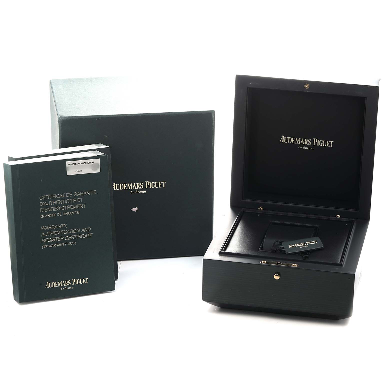 The image shows the Audemars Piguet Royal Oak 15400OR Men's Rose Gold Silver Dial packaging, including a box, booklet, and certificate, from a side angle.