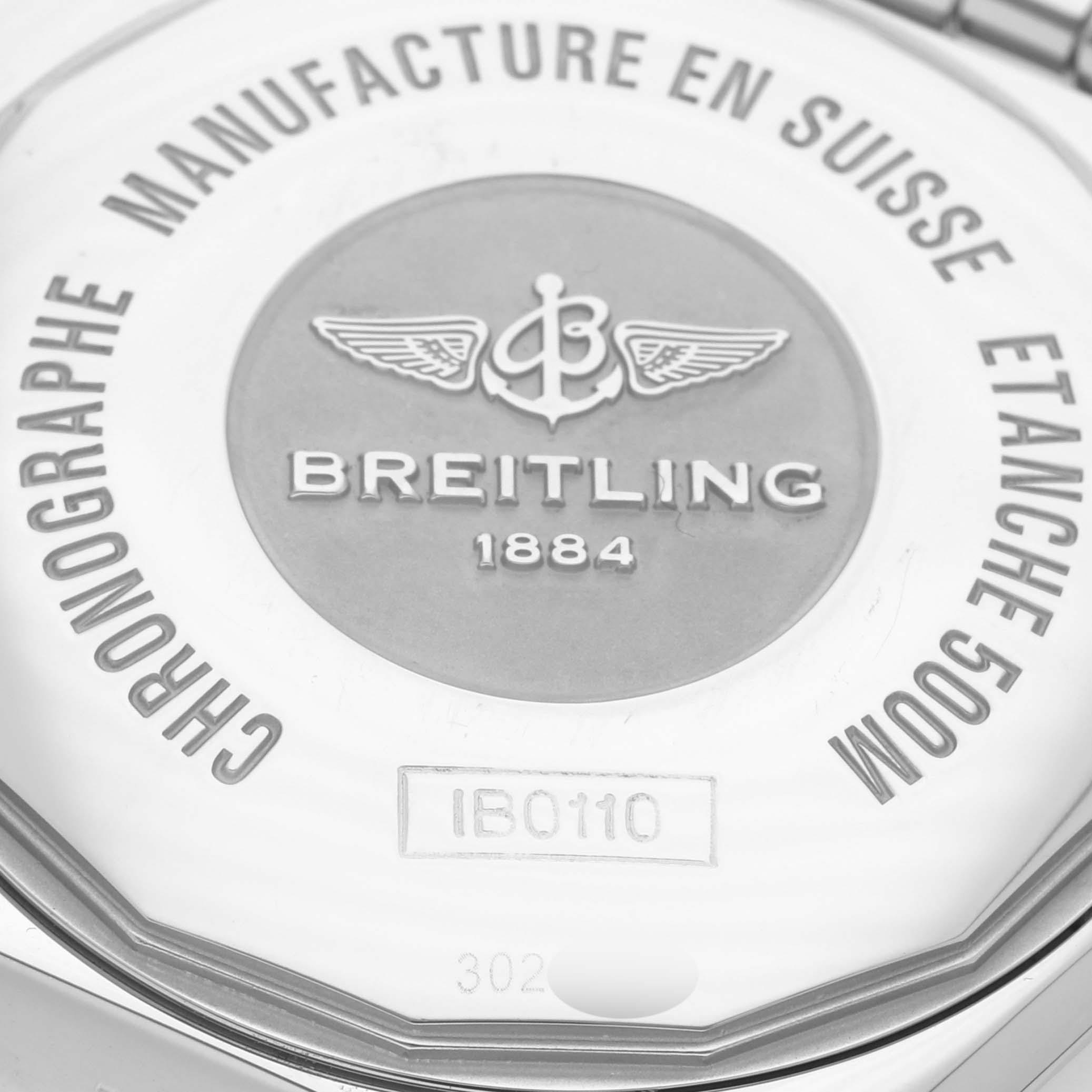 The image shows the back of a Breitling Chronomat IB0110 Men's Steel and Gold (two tone) Mother of Pearl Dial IB0110 Men's Steel and Gold (two tone) Mother of Pearl Dial watch, focusing on the engraved logo and specifications.