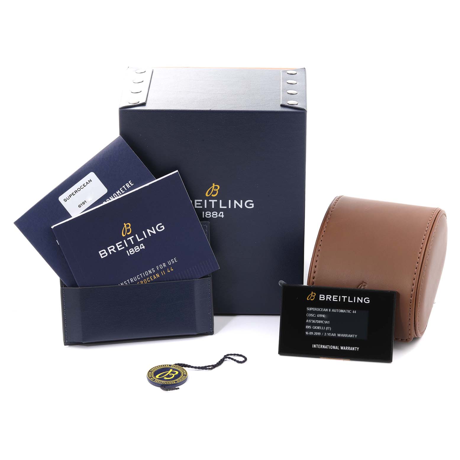 The image shows the packaging, instruction booklets, warranty card, and a leather case for a Breitling Superocean A17367 Men's Stainless Steel Blue Dial A17367 Men's Stainless Steel Blue Dial watch, all at a front angle.