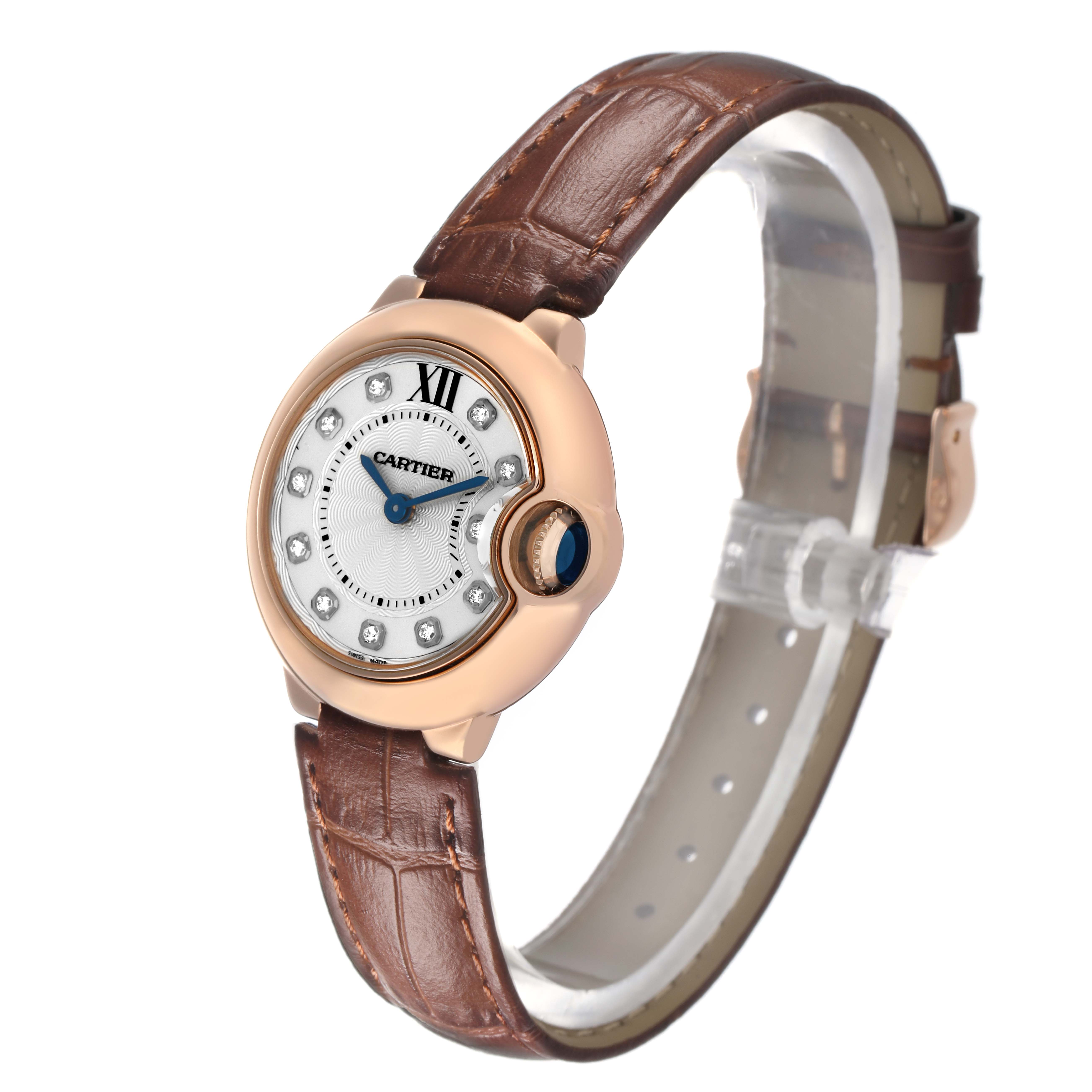 The Cartier Ballon Bleu WJBB0019 Women's Rose Gold Silver Dial watch is shown from a front-right angle, highlighting the face, crown, and leather strap.