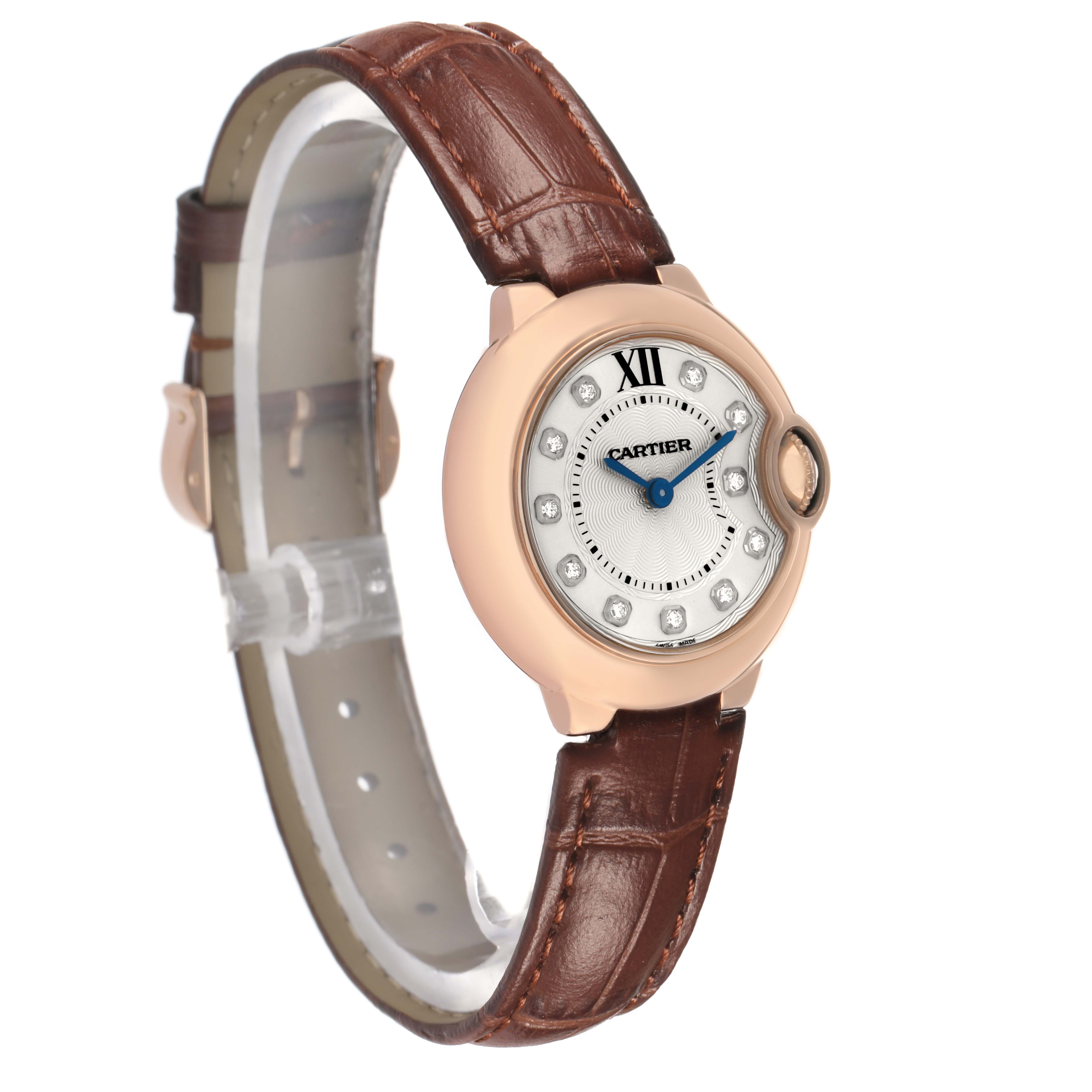 The Cartier Ballon Bleu WJBB0019 Women's Rose Gold Silver Dial watch is shown at an angled side view, highlighting the face, crown, and brown leather strap.