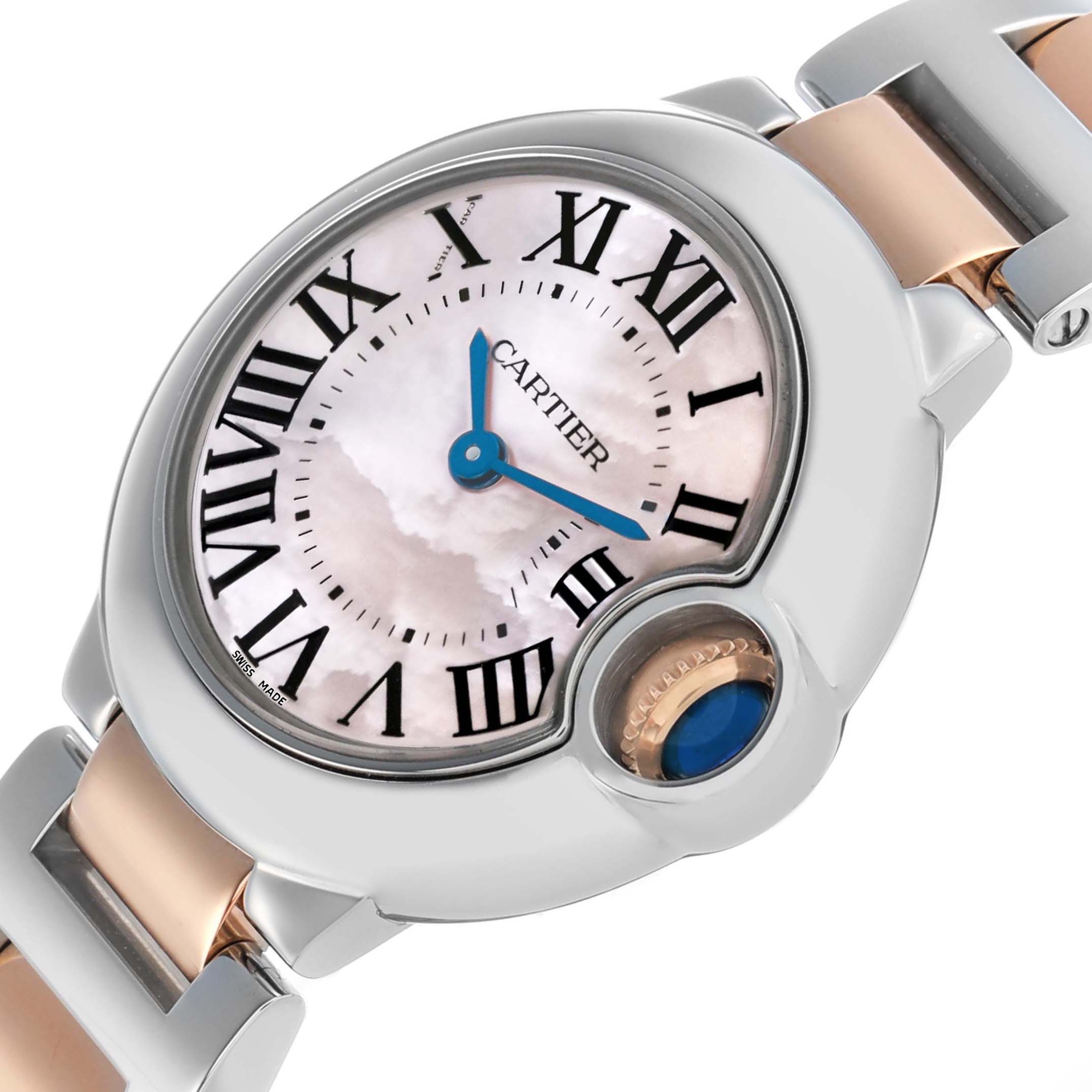 The Cartier Ballon Bleu W6920034 Women's Steel and Gold (two tone) Mother of Pearl Dial watch is angled to show the face, Roman numerals, blue hands, and crown with a blue cabochon.
