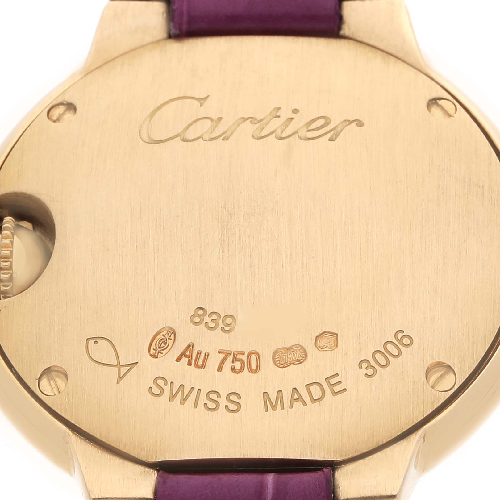 The image shows the back of a Cartier Ballon Bleu W6900156 Women's Yellow Gold Silver Dial watch, highlighting engraving details and markings.
