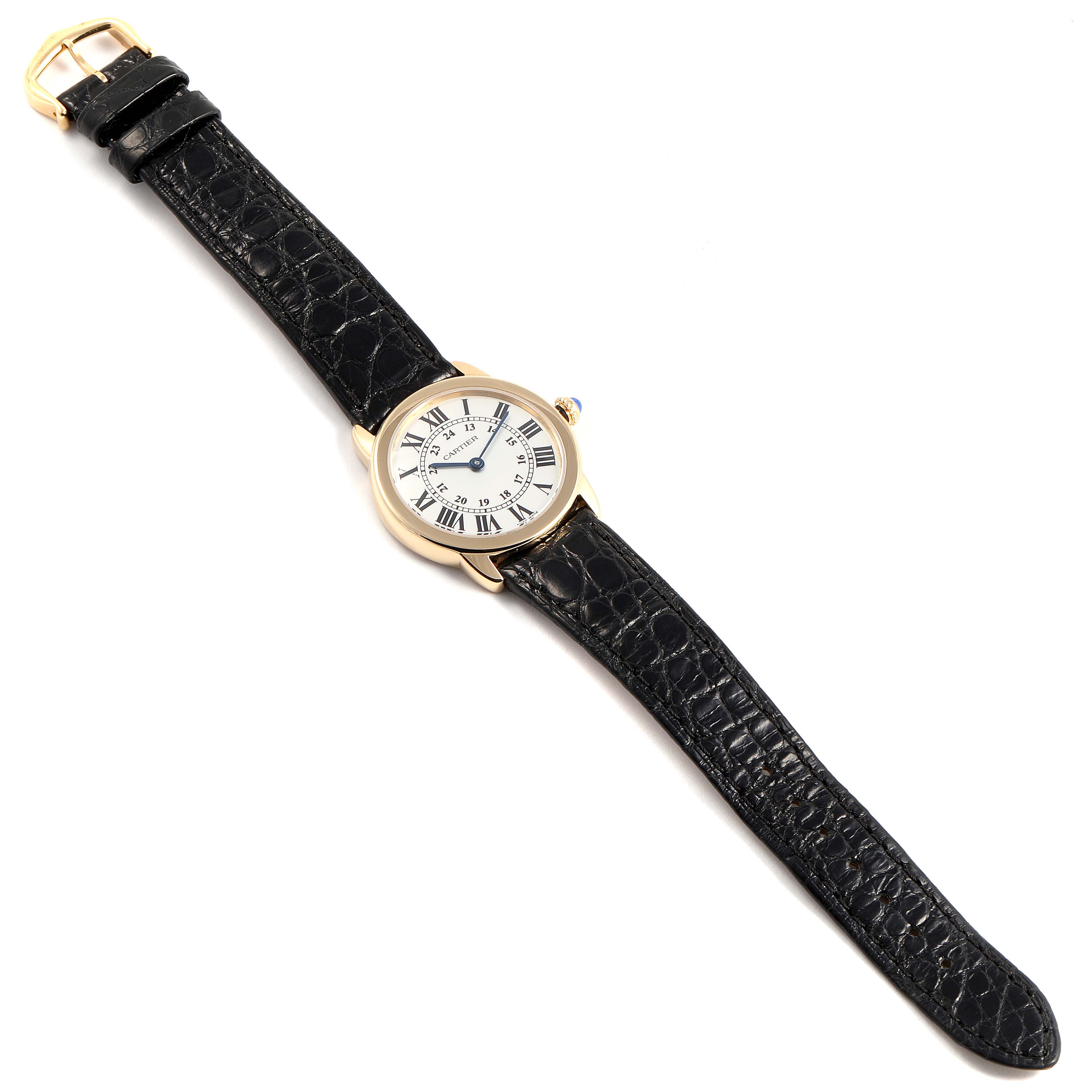 The Cartier Ronde W6700355 Women's Yellow Gold Silver Dial W6700355 Women's Yellow Gold Silver Dial model watch is shown from a top view, displaying its black leather strap and round face with Roman numerals.