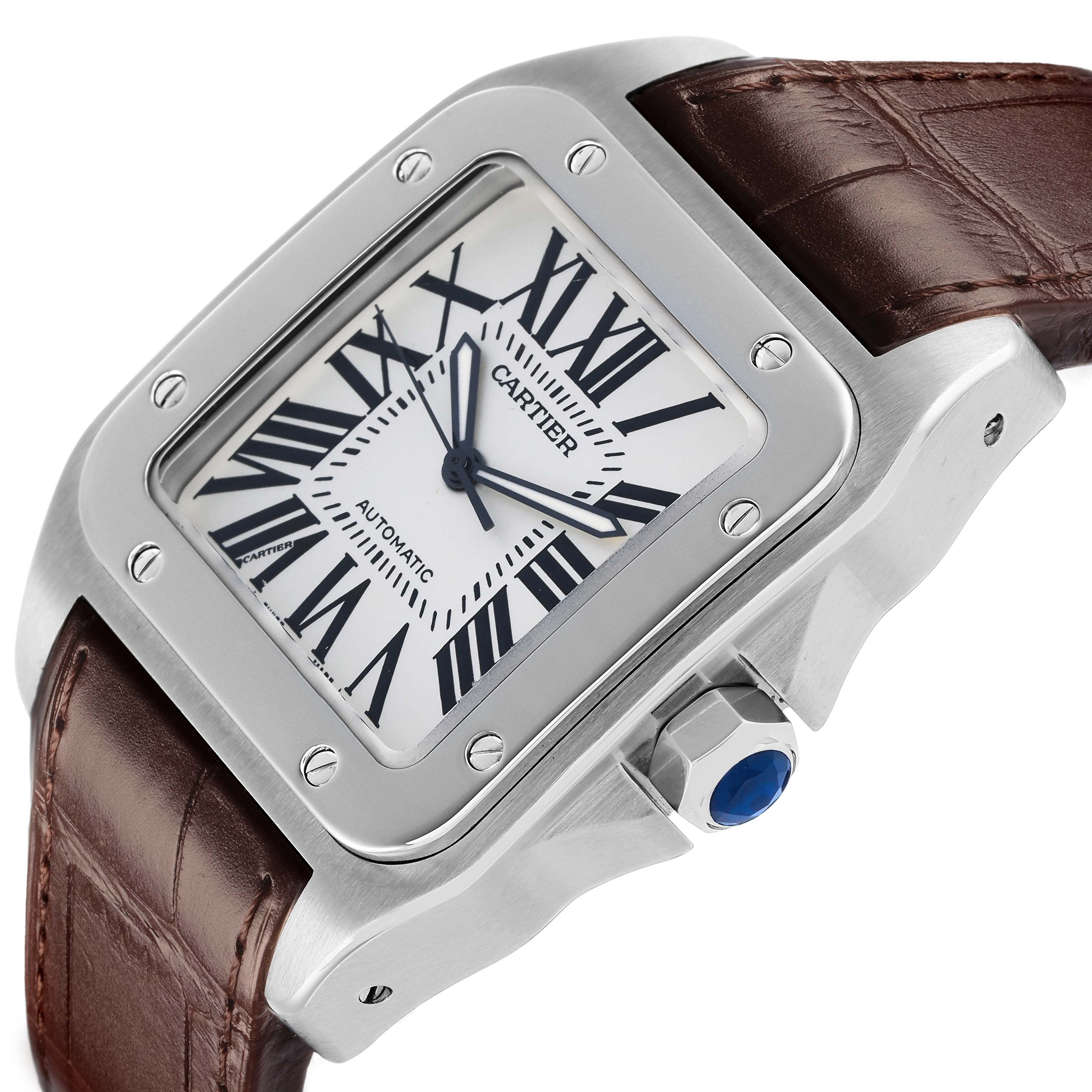 The Cartier Santos W20073X8 Men's Stainless Steel Silver Dial watch is shown at an angle highlighting the face, bezel, crown with blue cabochon, and brown leather strap.