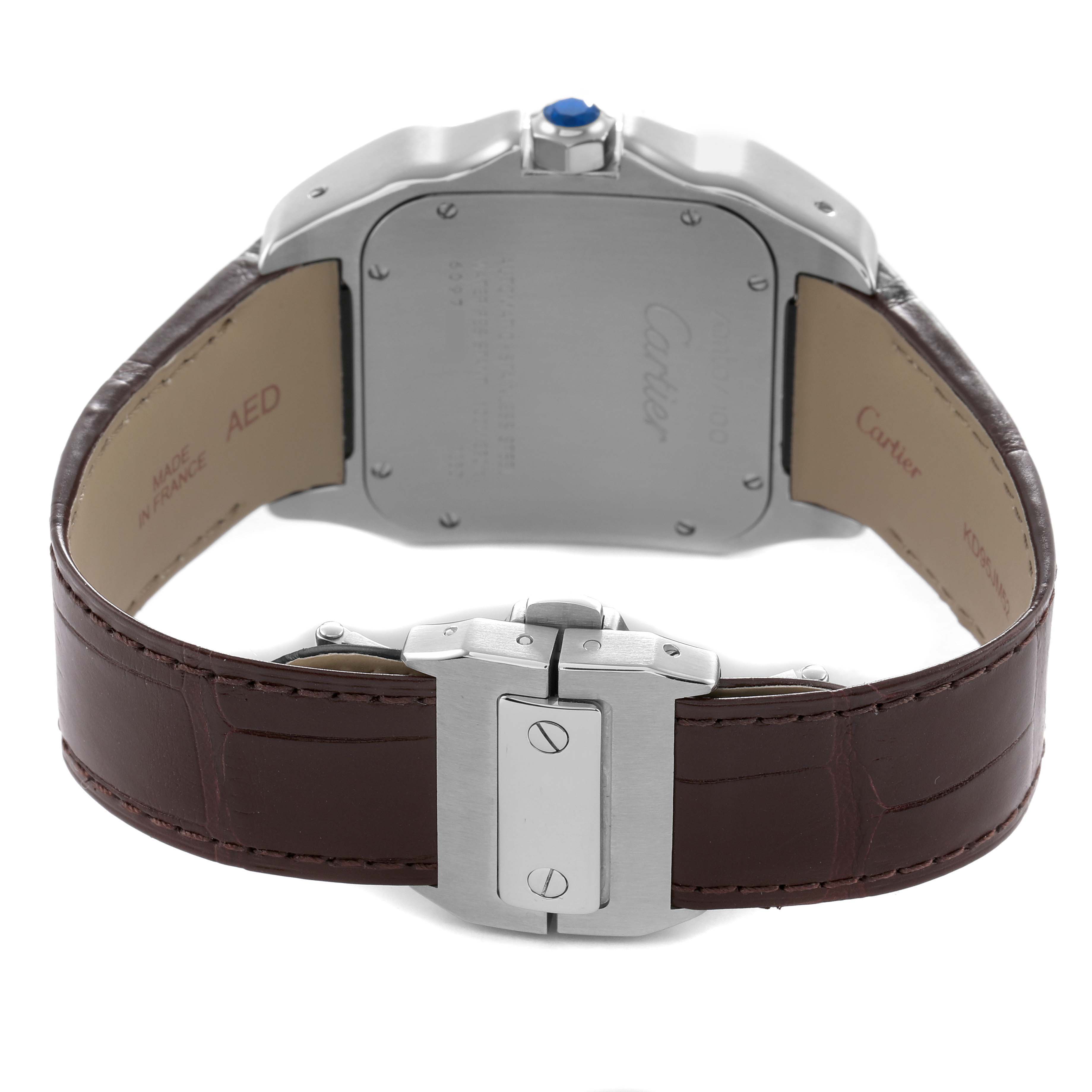 The image shows the back and clasp of a Cartier Santos W20073X8 Men's Stainless Steel Silver Dial watch with a brown leather strap and visible screws.