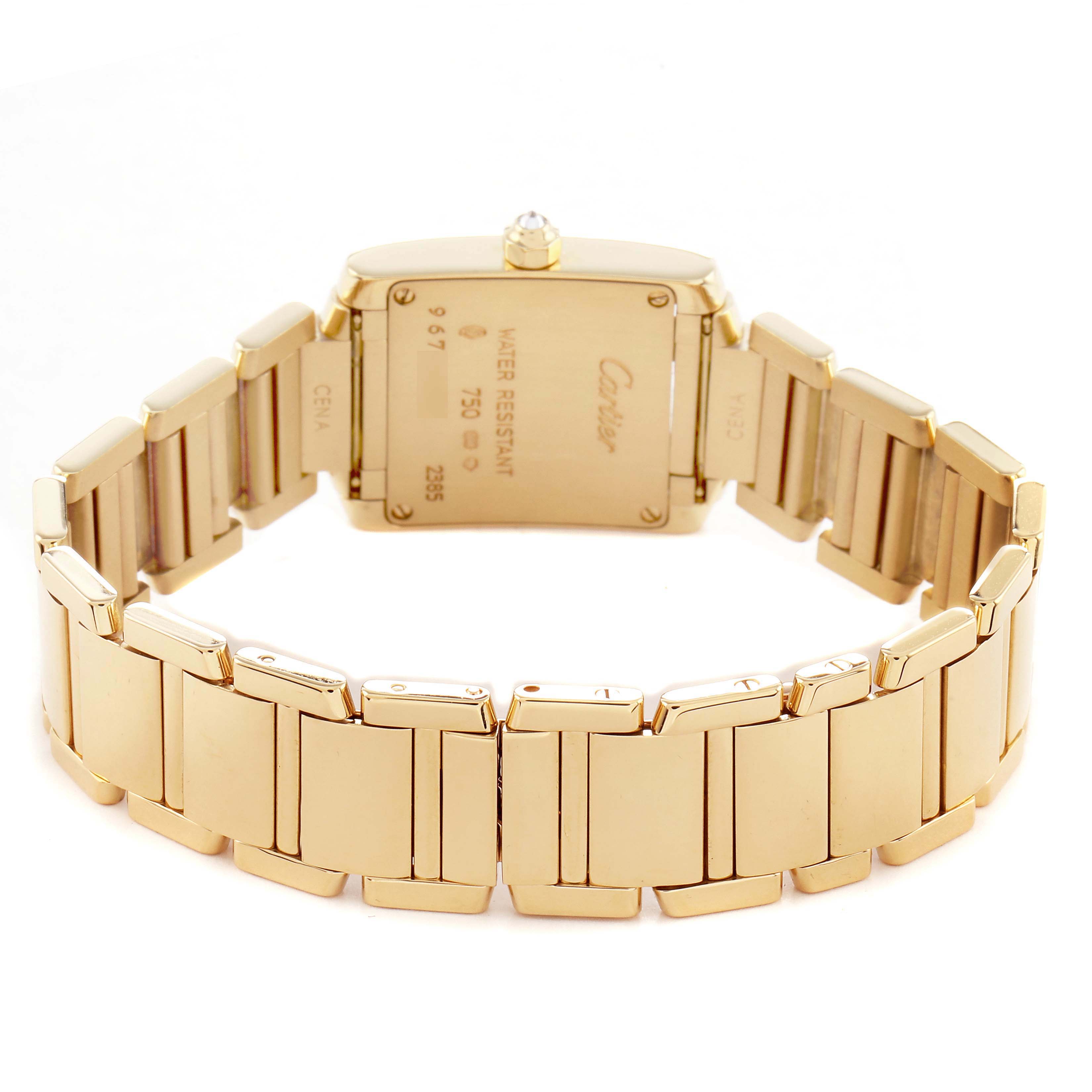The Cartier Tank Française watch is shown from the back, highlighting the case back and gold bracelet.