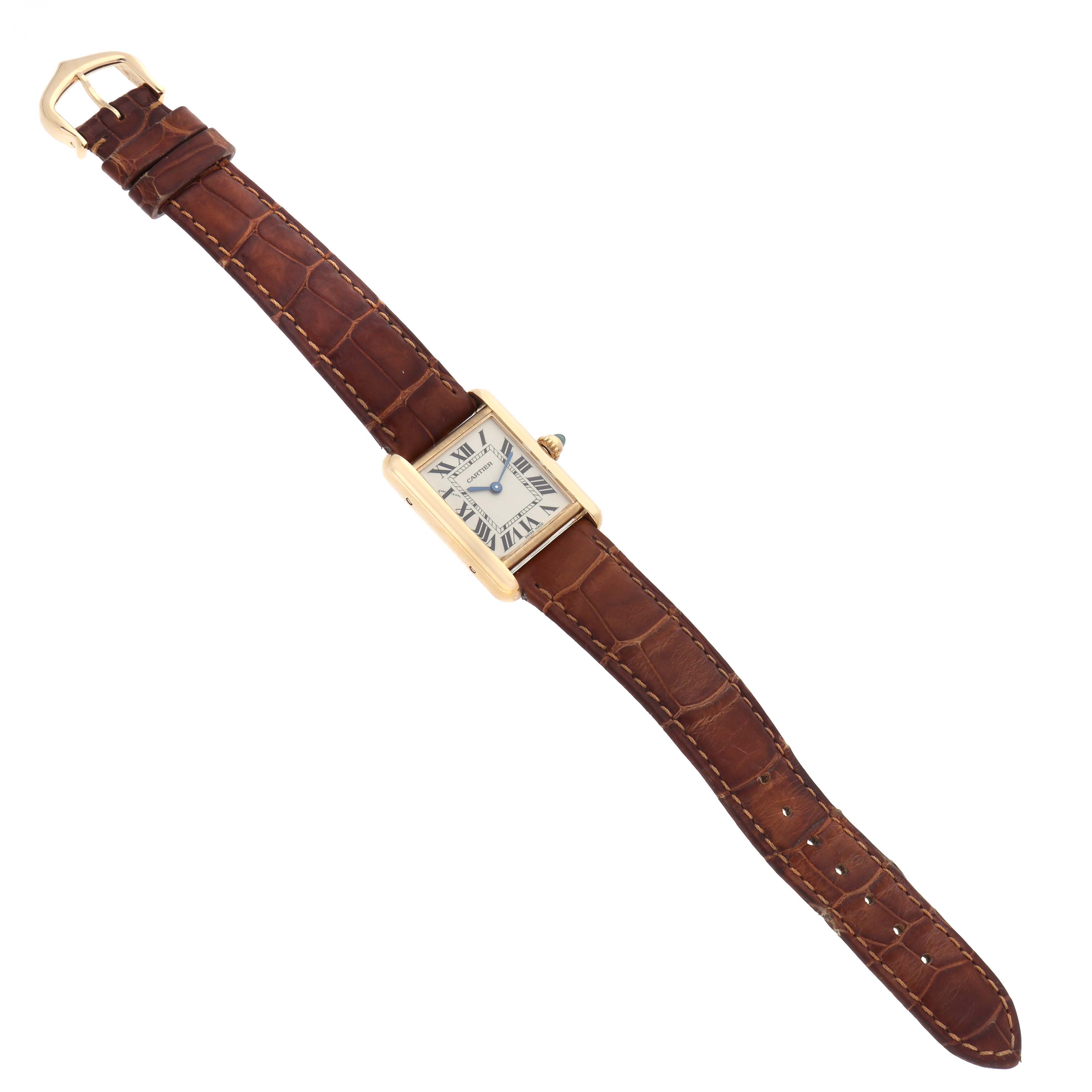 The Cartier Tank Louis W1529856 Women's Yellow Gold Silver Dial watch is shown from a top-down angle, displaying the face and the full leather strap.