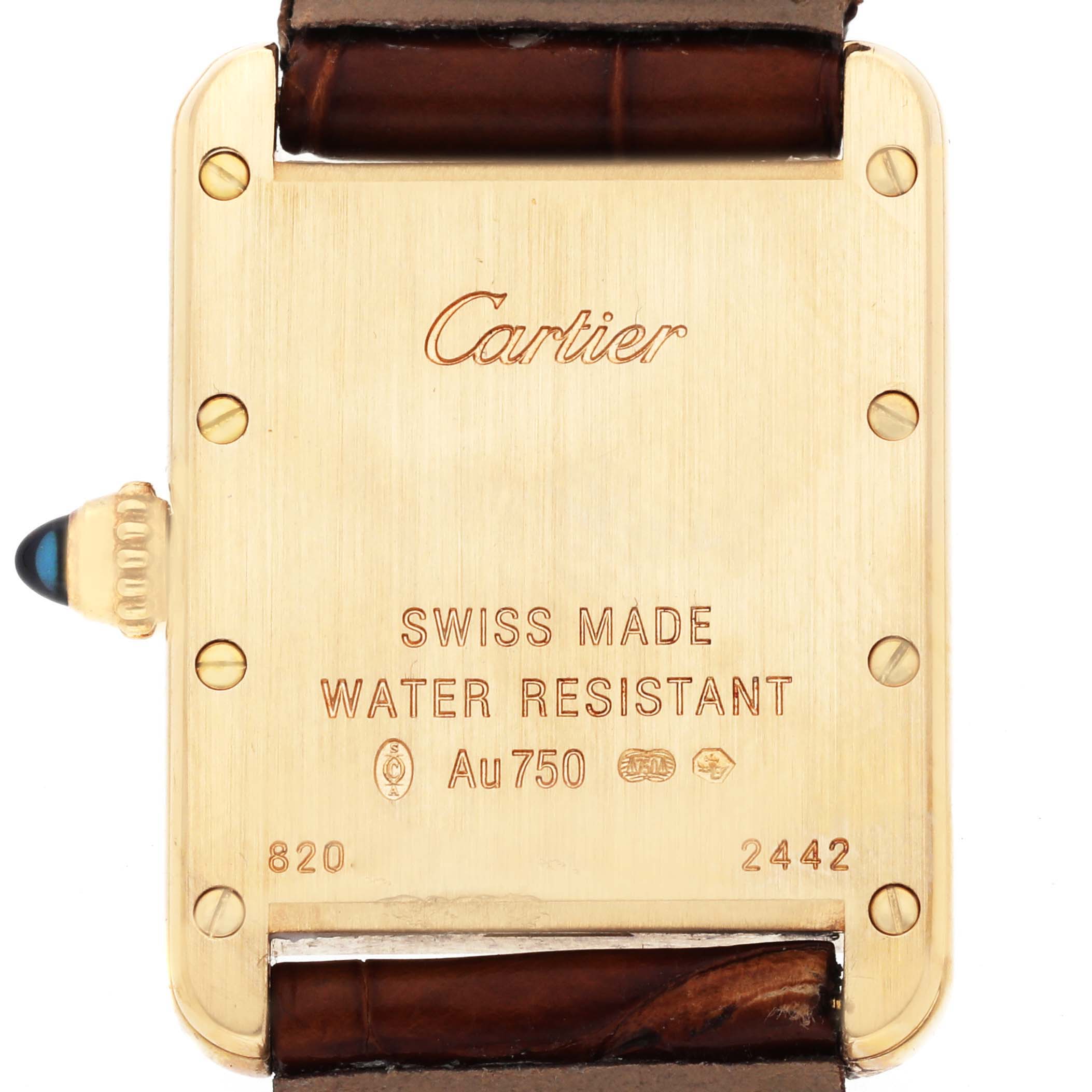 The image shows the back of a Cartier Tank Louis W1529856 Women's Yellow Gold Silver Dial watch, highlighting its case with engravings and part of the leather strap.