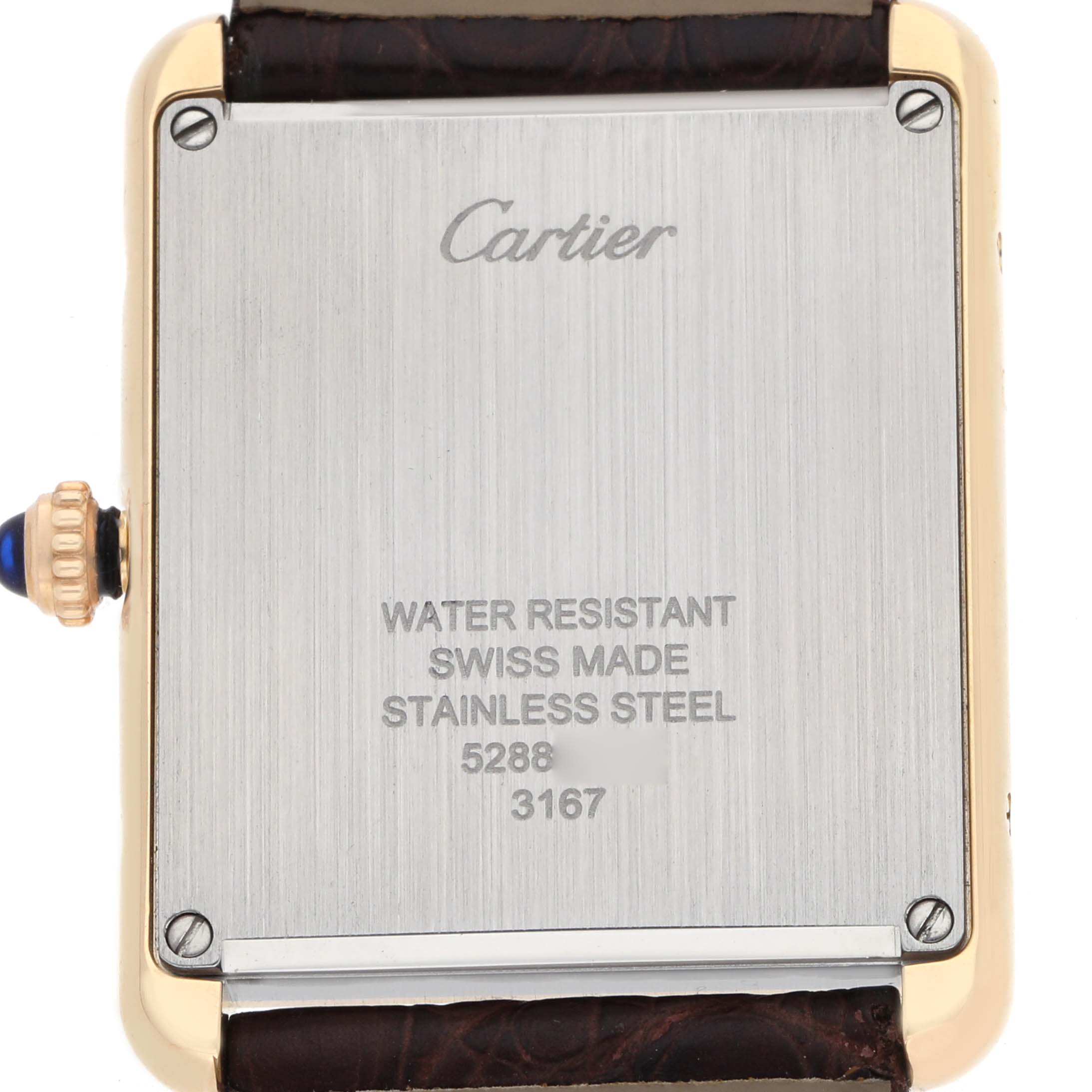 The Cartier Tank Solo W5200025 Men's Steel and Gold (two tone) Silver Dial watch is shown from the back, displaying its stainless steel case, inscriptions, and brown leather strap.