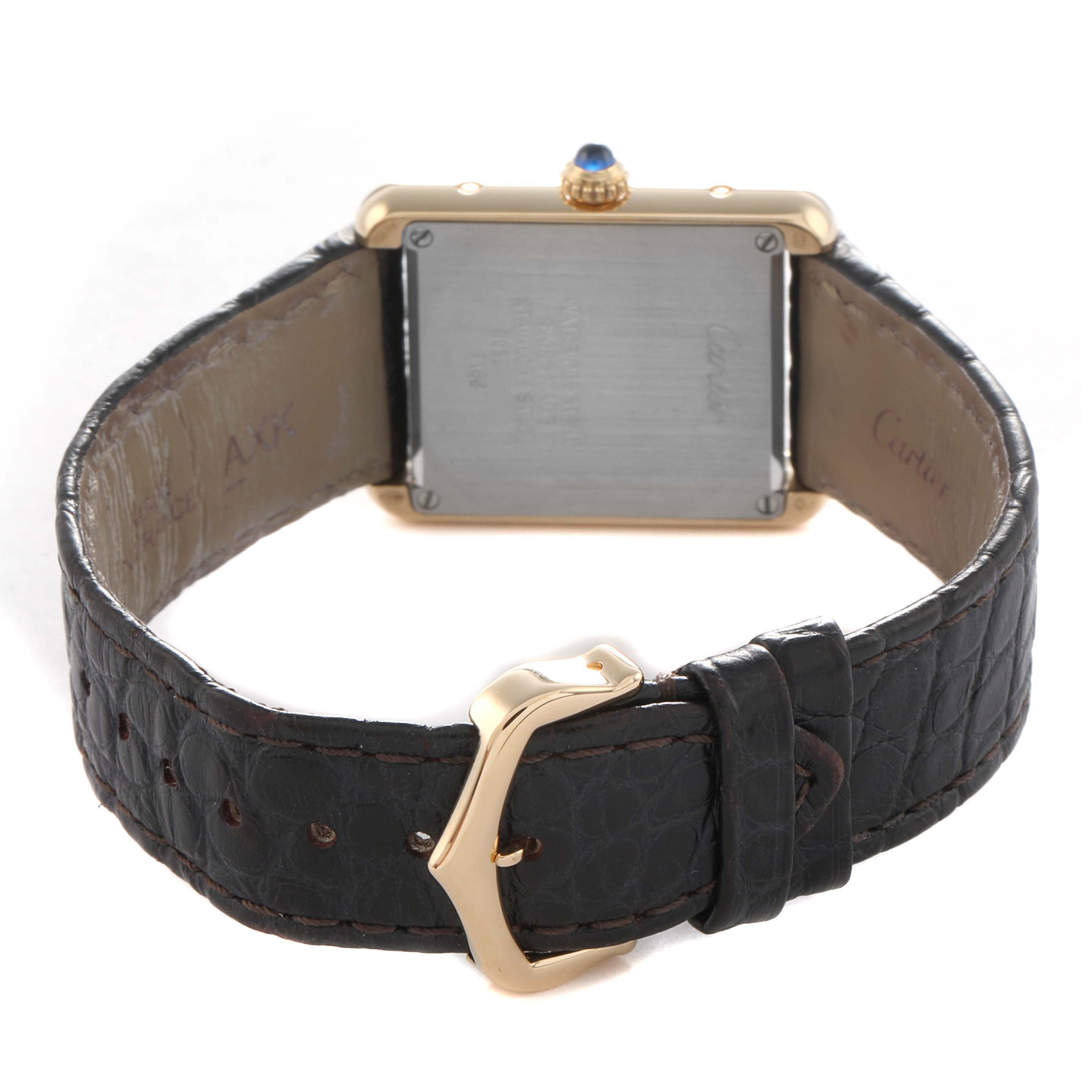 The Cartier Tank Solo W5200002 Women's Steel and Gold (two tone) Silver Dial watch is shown from the back, highlighting the case, strap, buckle, and crown with a blue gemstone.