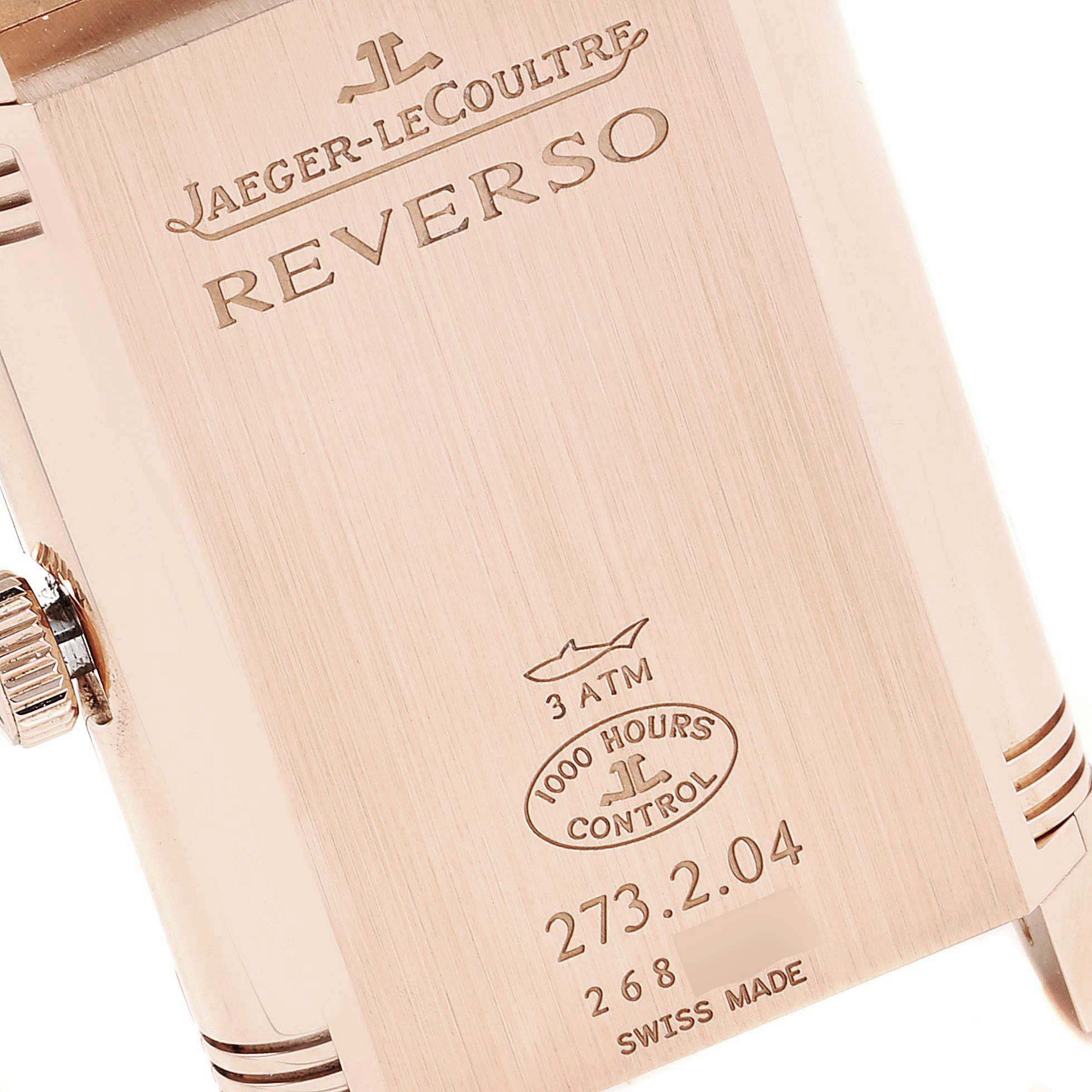 This image shows the back casing of a Jaeger-LeCoultre Reverso watch, displaying its engravings and crown at an angle.