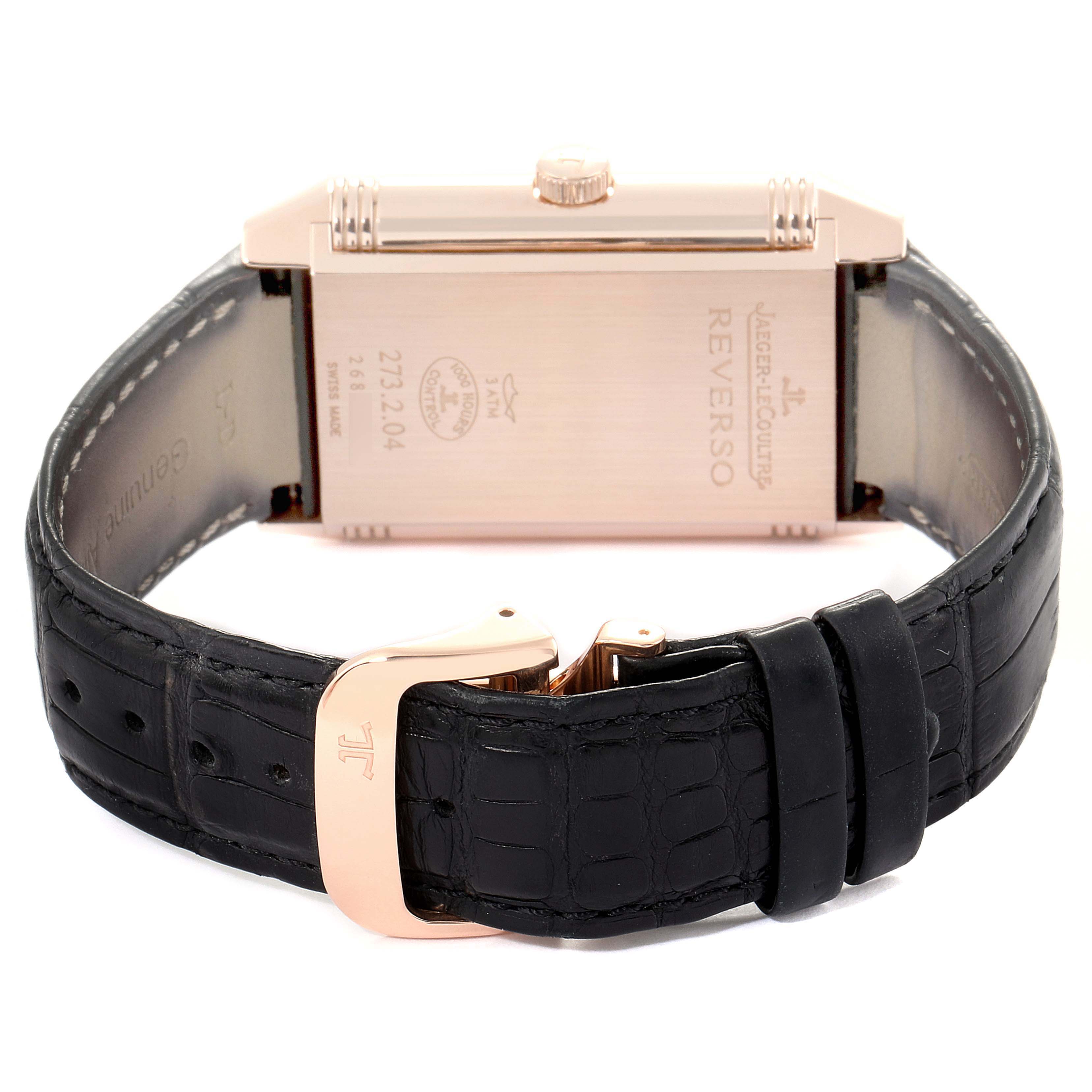The image shows the reverse side of a Jaeger LeCoultre Reverso Q3732470 Men's Rose Gold Black Dial Q3732470 Men's Rose Gold Black Dial watch, including the case back, crown, and black leather strap with a clasp.