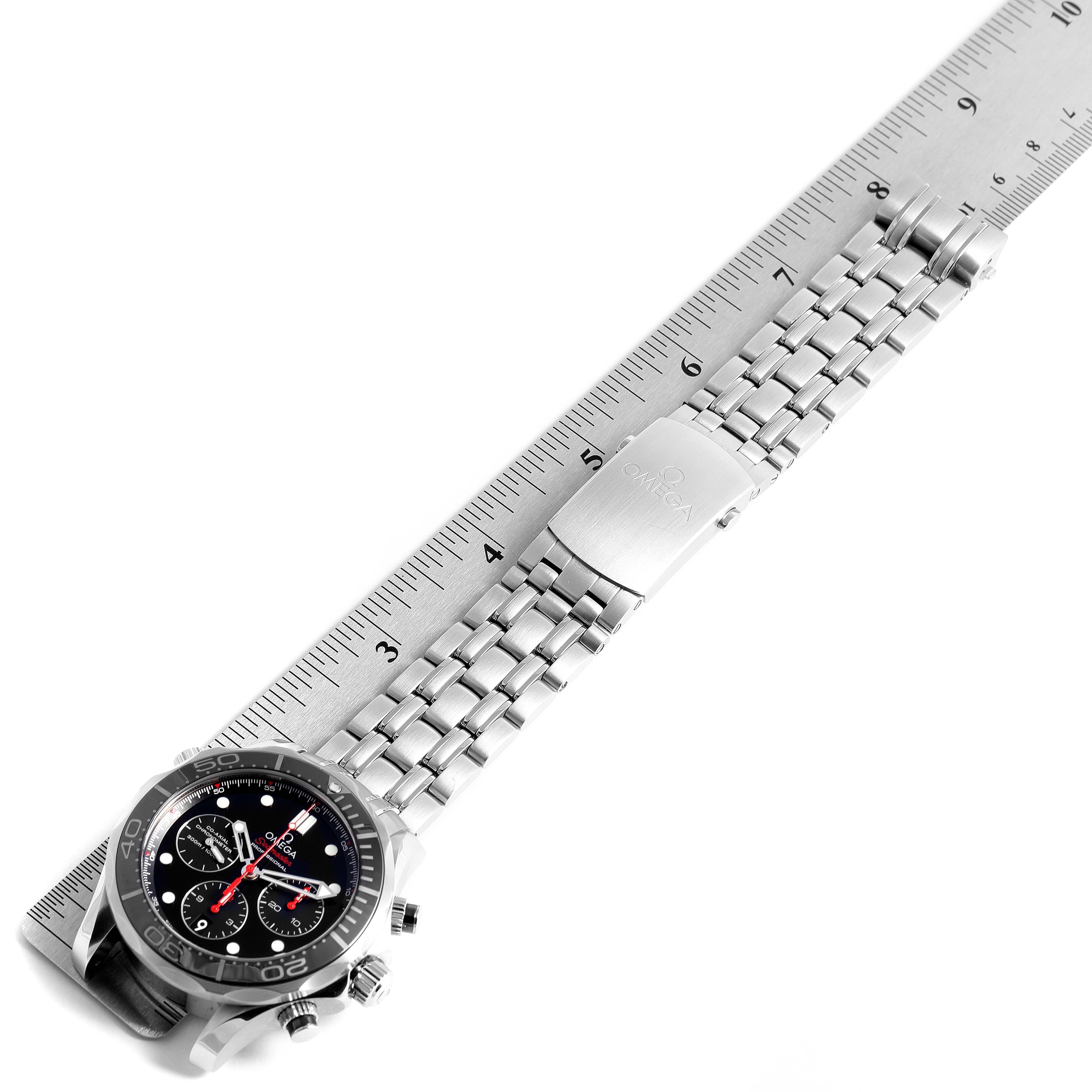 The image shows an Omega Seamaster 212.30.44.50.01.001 Men
s Stainless Steel Black Dial 212.30.44.50.01.001 Men
s Stainless Steel Black Dial watch laid flat alongside a ruler, displaying its face, bracelet, and clasp.