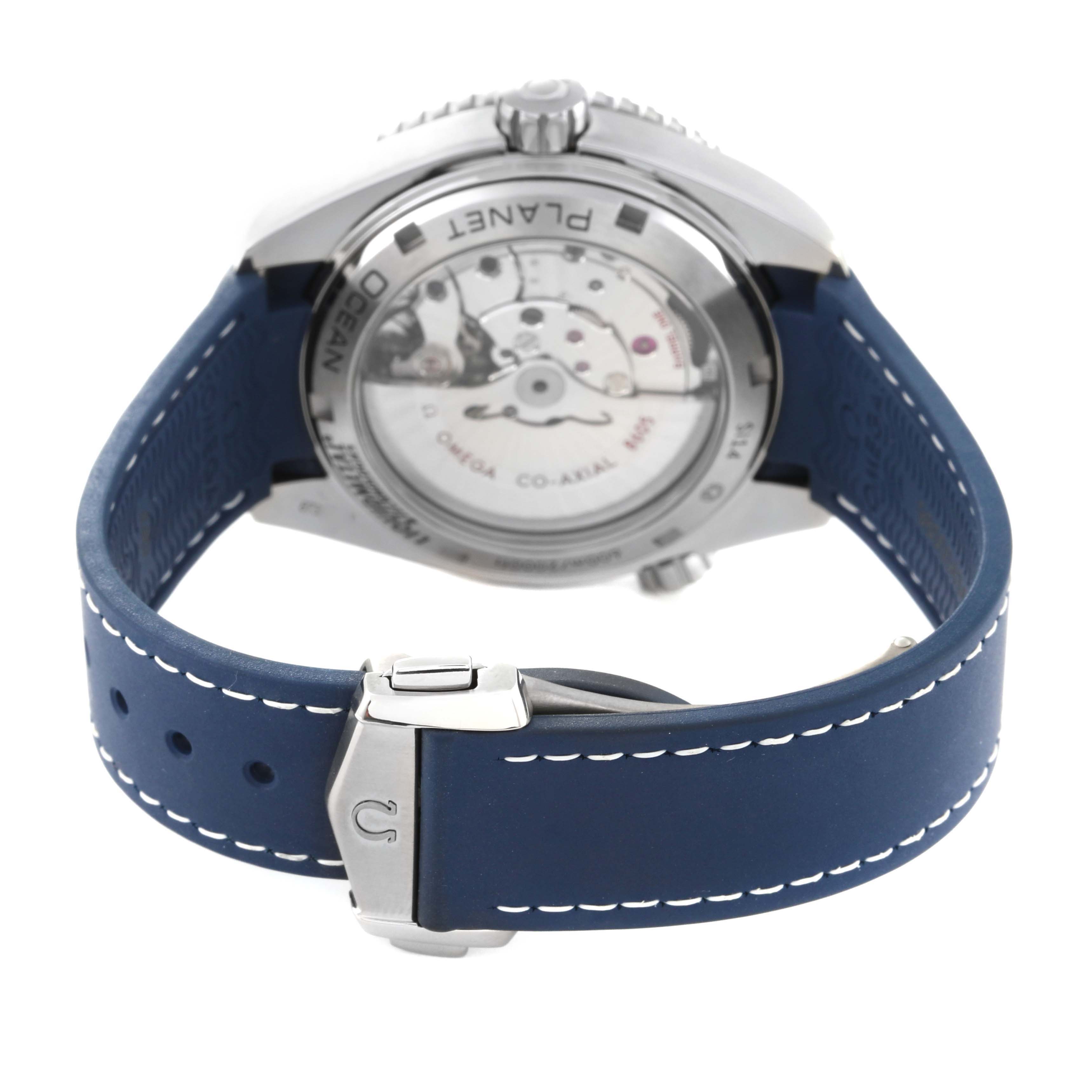 The image shows the back view of the Omega Planet Ocean 232.92.44.22.03.001 Men
s Stainless Steel Blue Dial 232.92.44.22.03.001 Men
s Stainless Steel Blue Dial watch, highlighting its movement and blue strap with buckle.