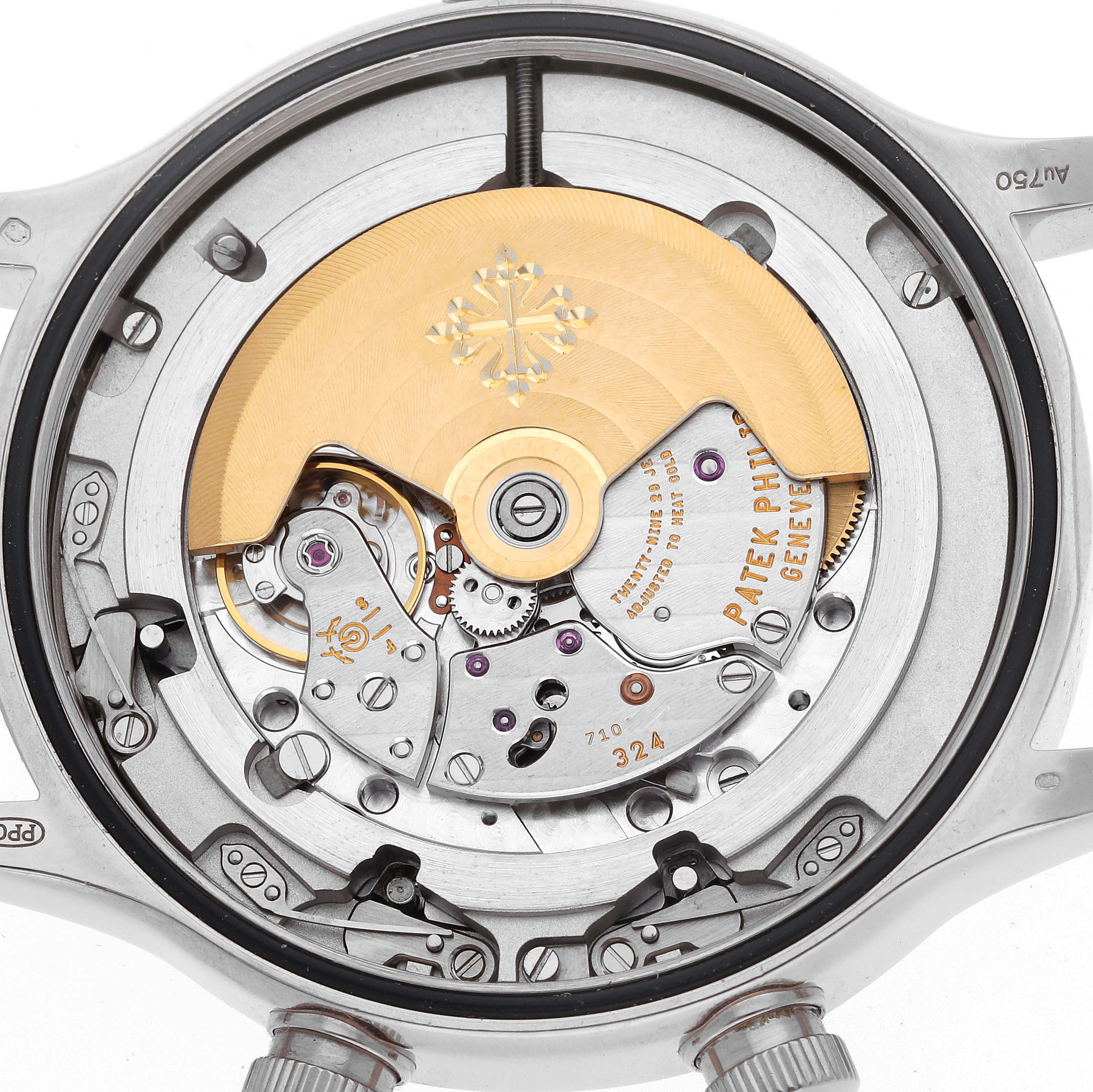 The image shows the movement and intricate components of a Patek Philippe Calatrava 5524G Men's White Gold Blue Dial watch from a top-down angle.