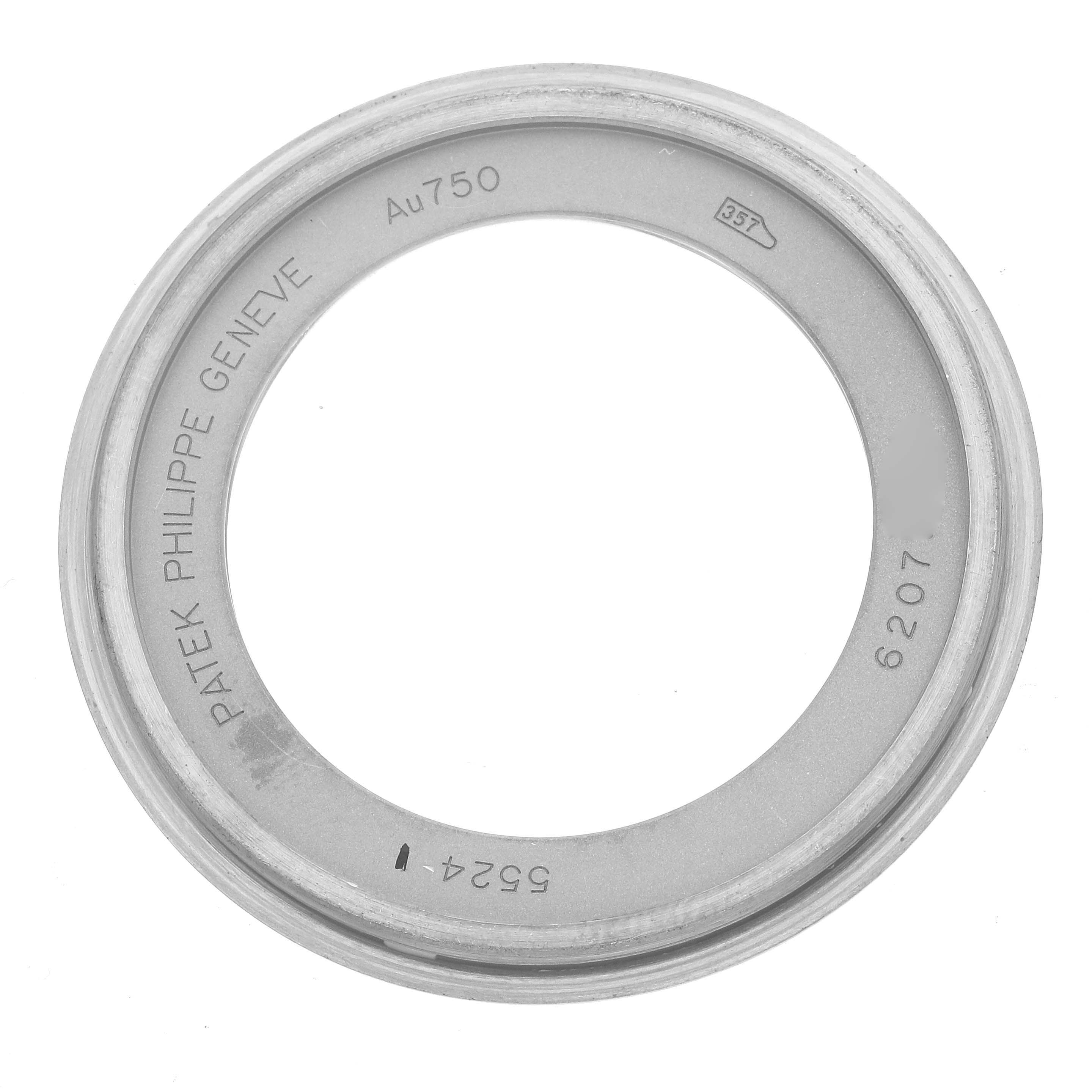 The image shows a top view of a Patek Philippe Calatrava 5524G Men's White Gold Blue Dial watch bezel with engravings.