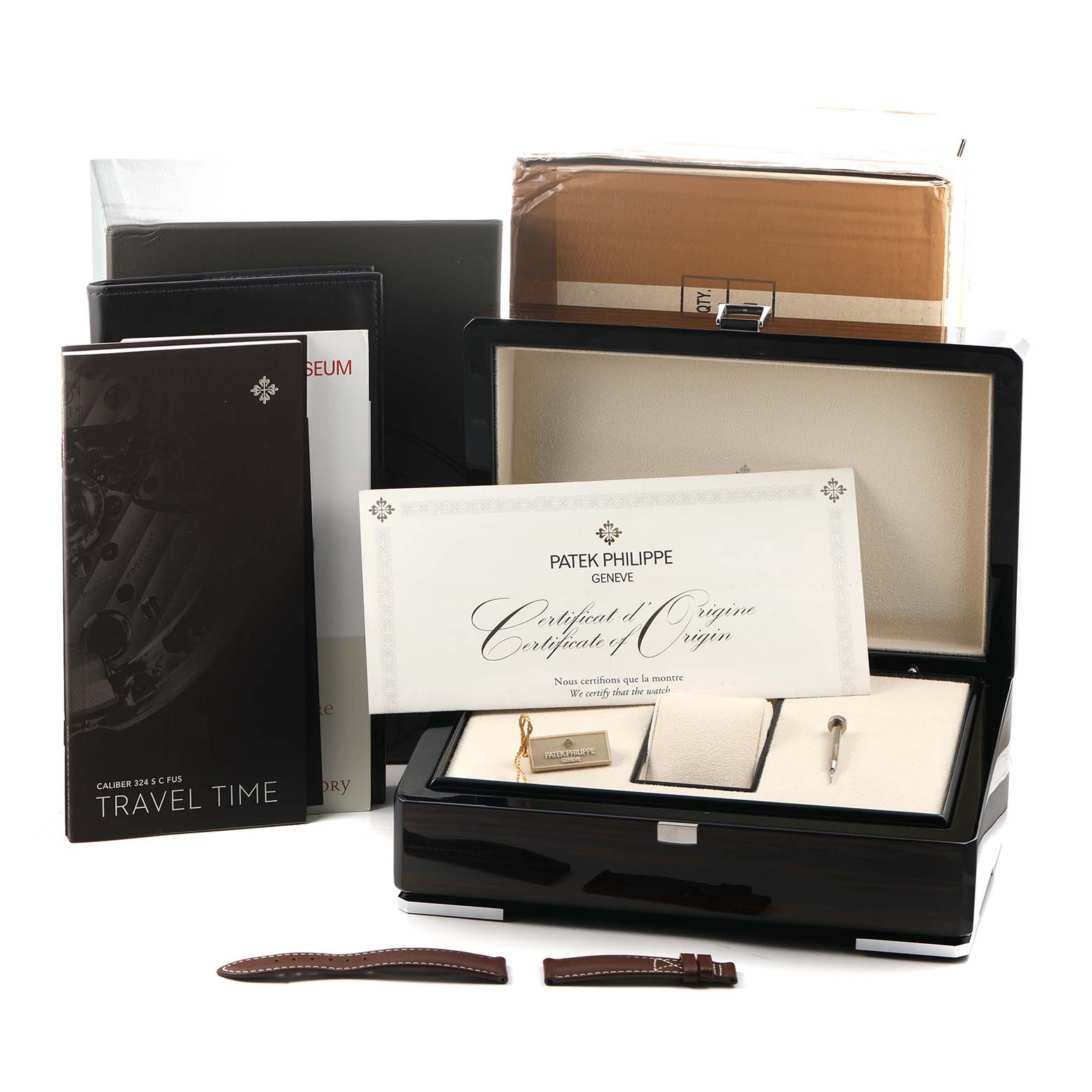 The image shows Patek Philippe Calatrava 5524G Men's White Gold Blue Dial accessories, including a box, certificate, manuals, and additional straps.