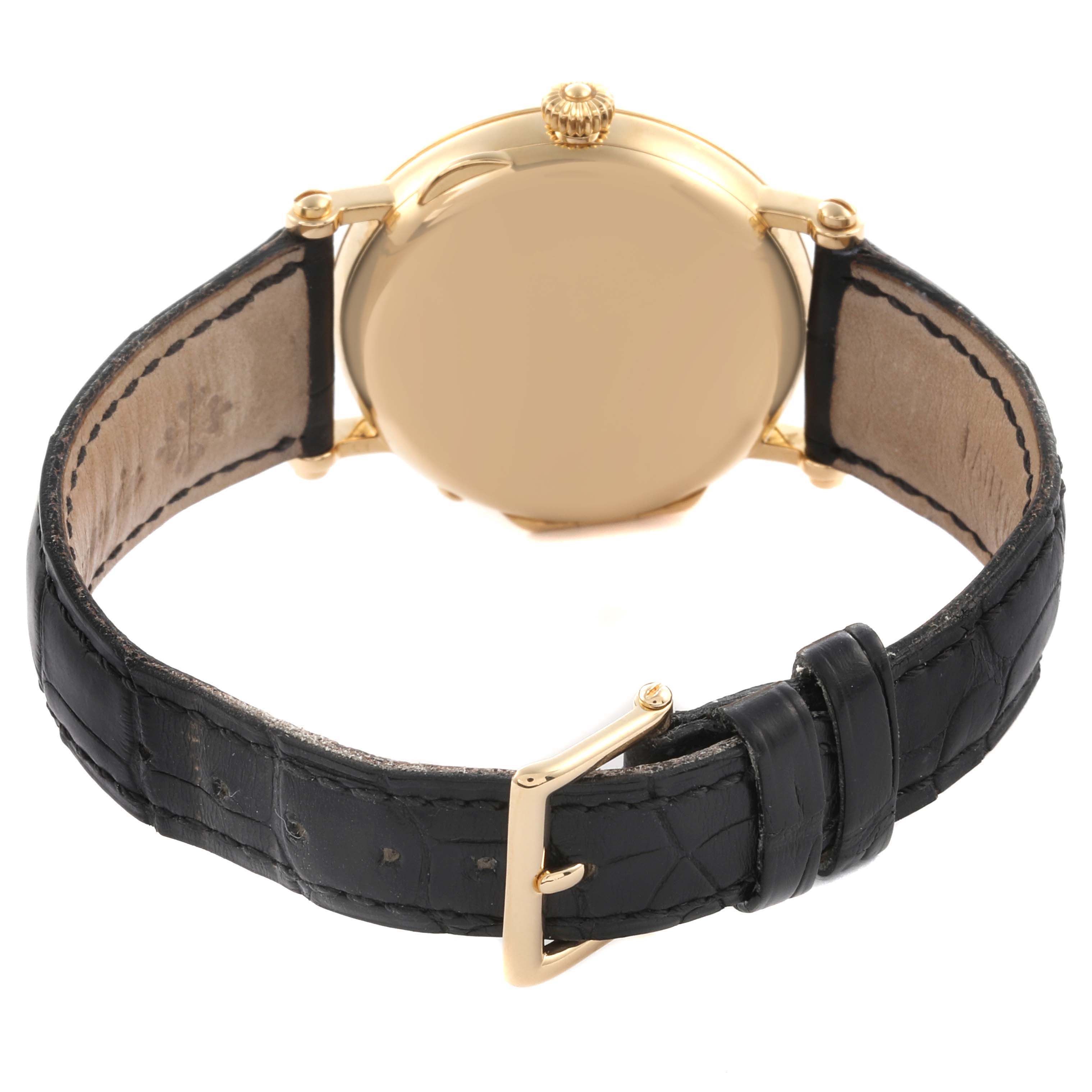 The Patek Philippe Calatrava 5015J-001 Men's Yellow Gold White Dial 5015J-001 Men's Yellow Gold White Dial watch is shown from the back, highlighting the gold case and black leather strap with buckle.