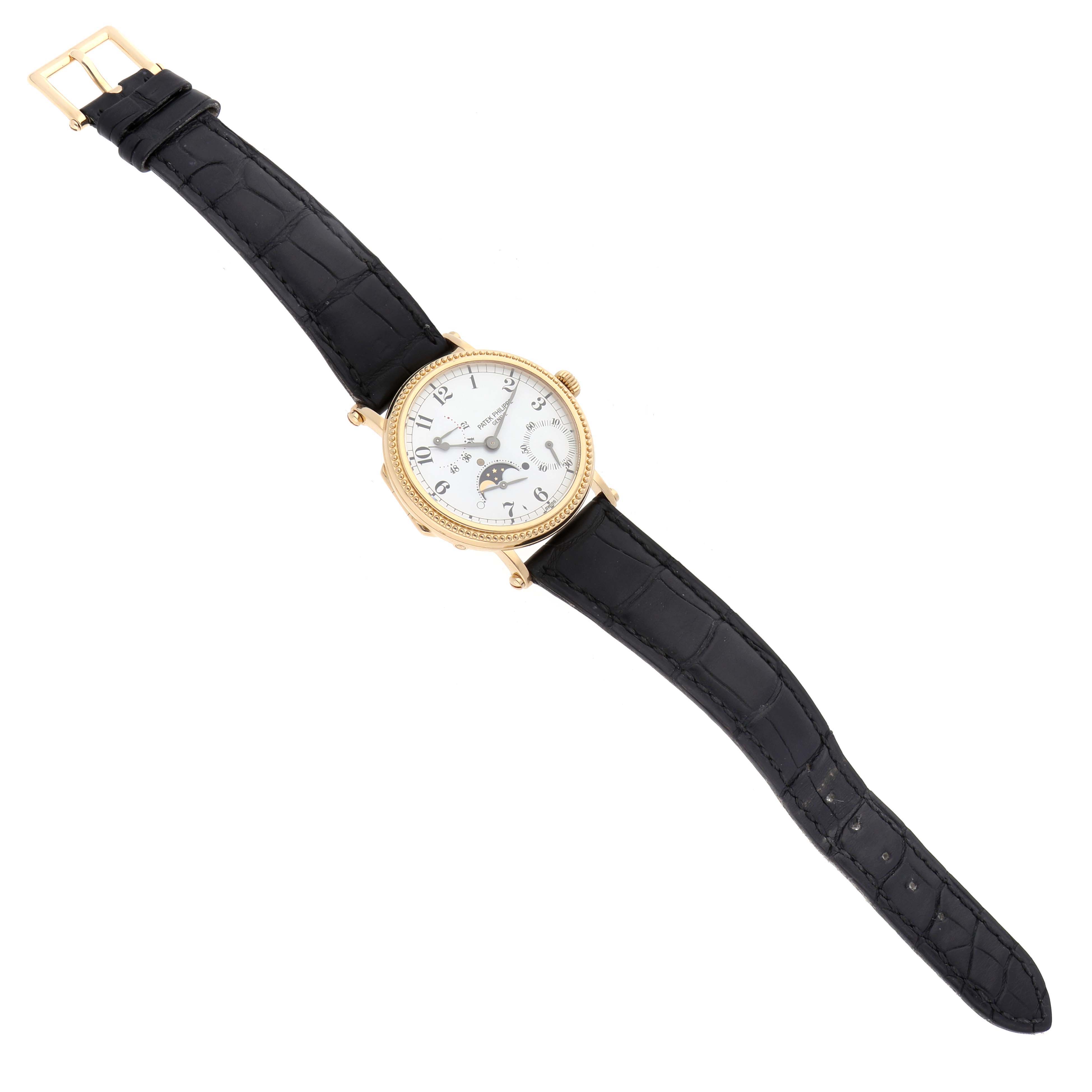 The Patek Philippe Calatrava 5015J-001 Men's Yellow Gold White Dial 5015J-001 Men's Yellow Gold White Dial watch is shown from a top view, displaying the face, case, and black leather strap.