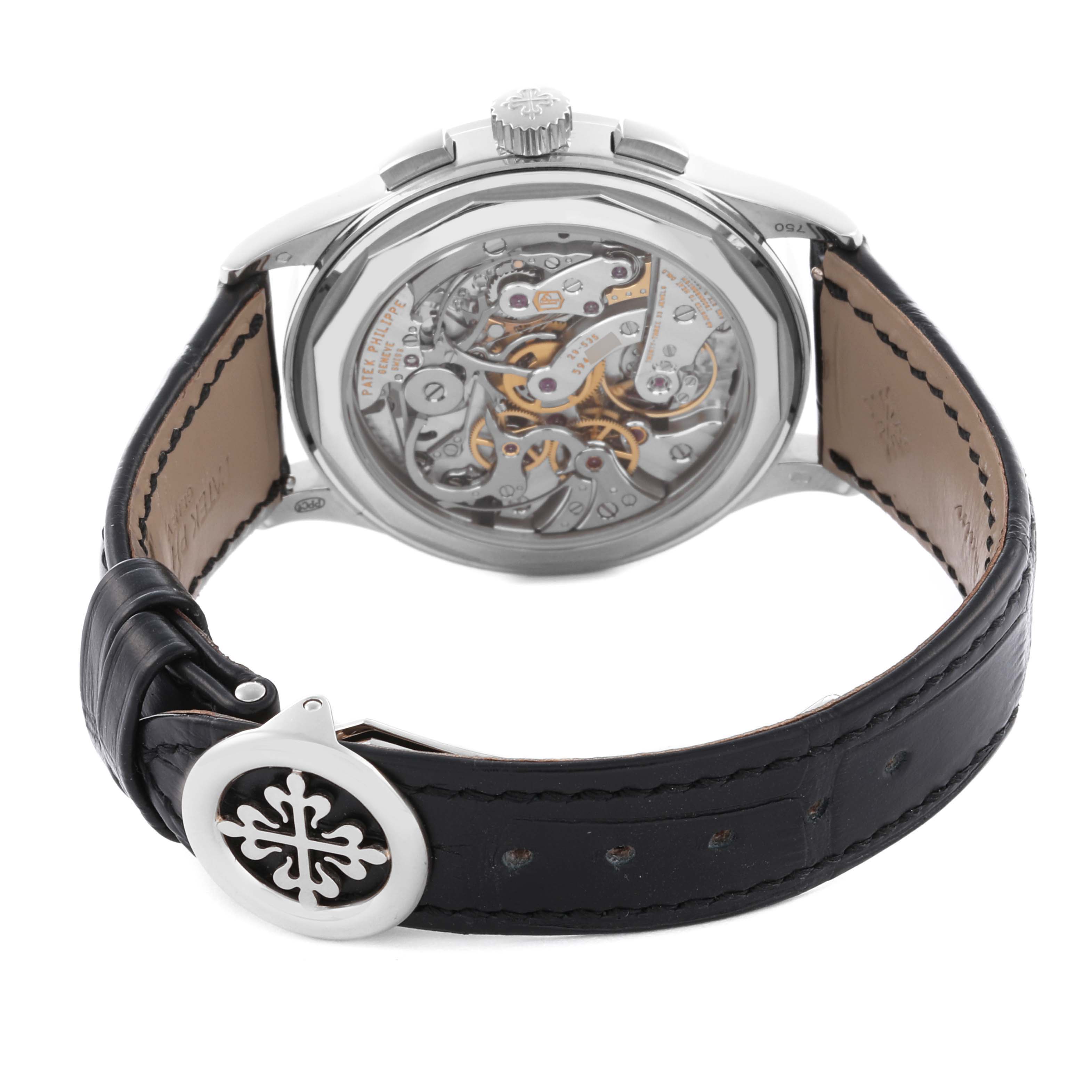 The image shows the back view of the Patek Philippe Complications 5170G-010 Men's White Gold Black Dial 5170G-010 Men's White Gold Black Dial watch, highlighting the movement and case back details.