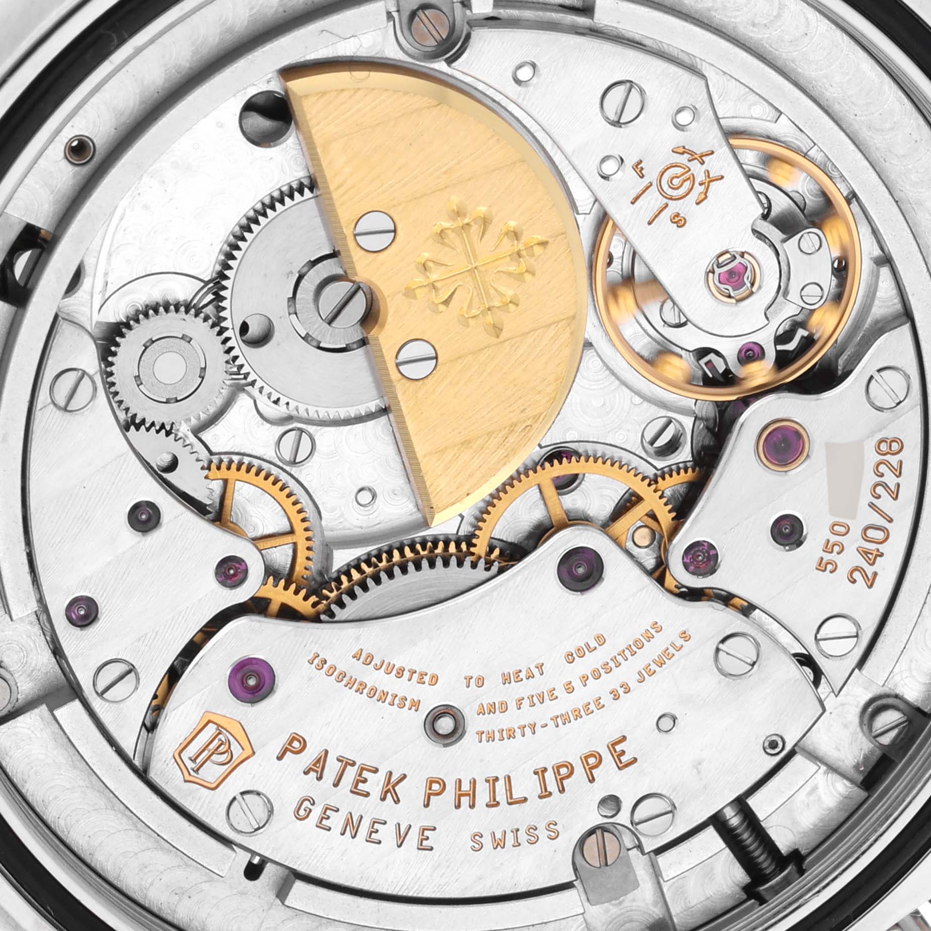 The image shows the movement and intricate components of a Patek Philippe Complications 5130G Men
s White Gold Silver Dial 5130G Men
s White Gold Silver Dial watch from a close-up angle.