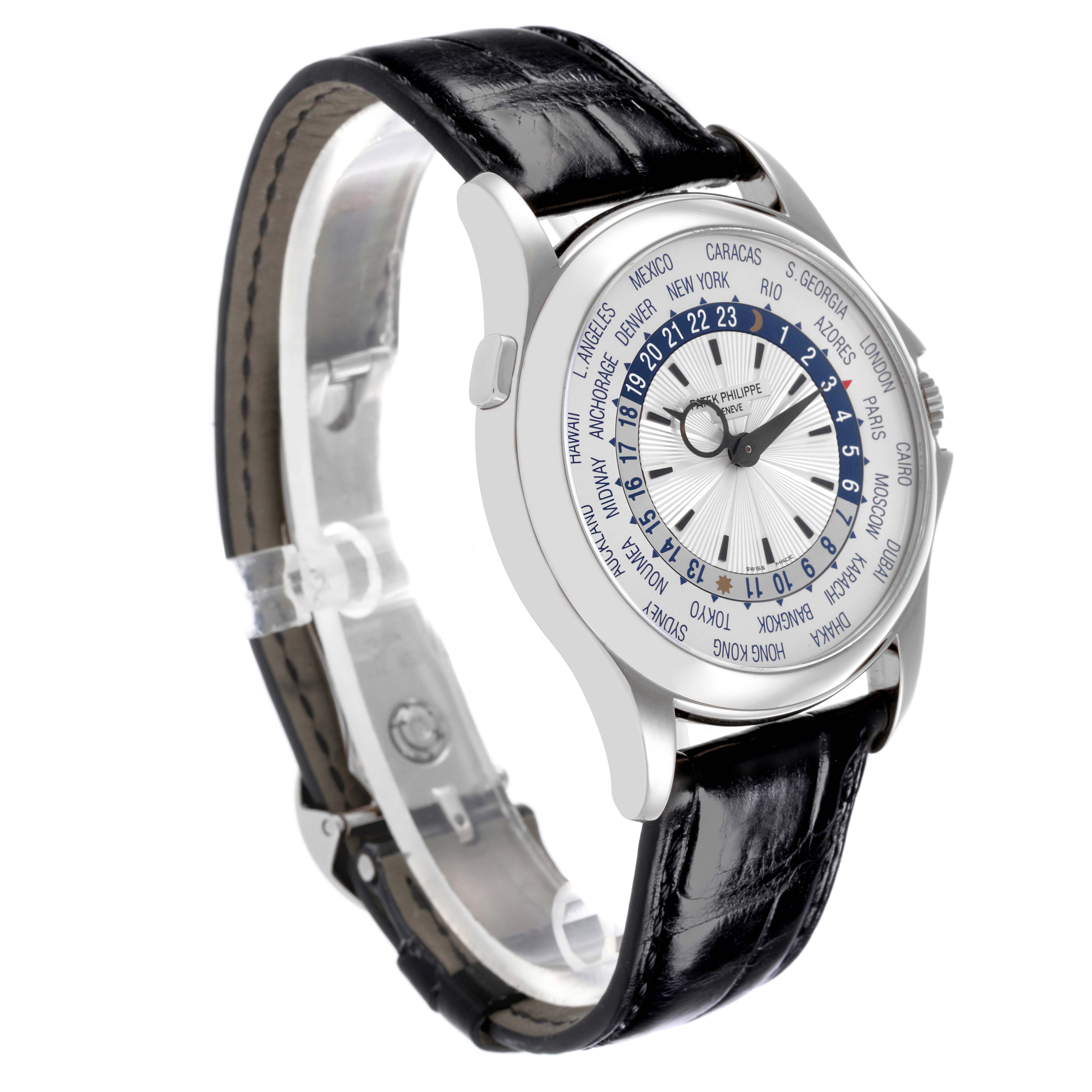 The Patek Philippe Complications 5130G Men
s White Gold Silver Dial 5130G Men
s White Gold Silver Dial watch is shown at an angled side view, highlighting the black leather strap and detailed world time dial.