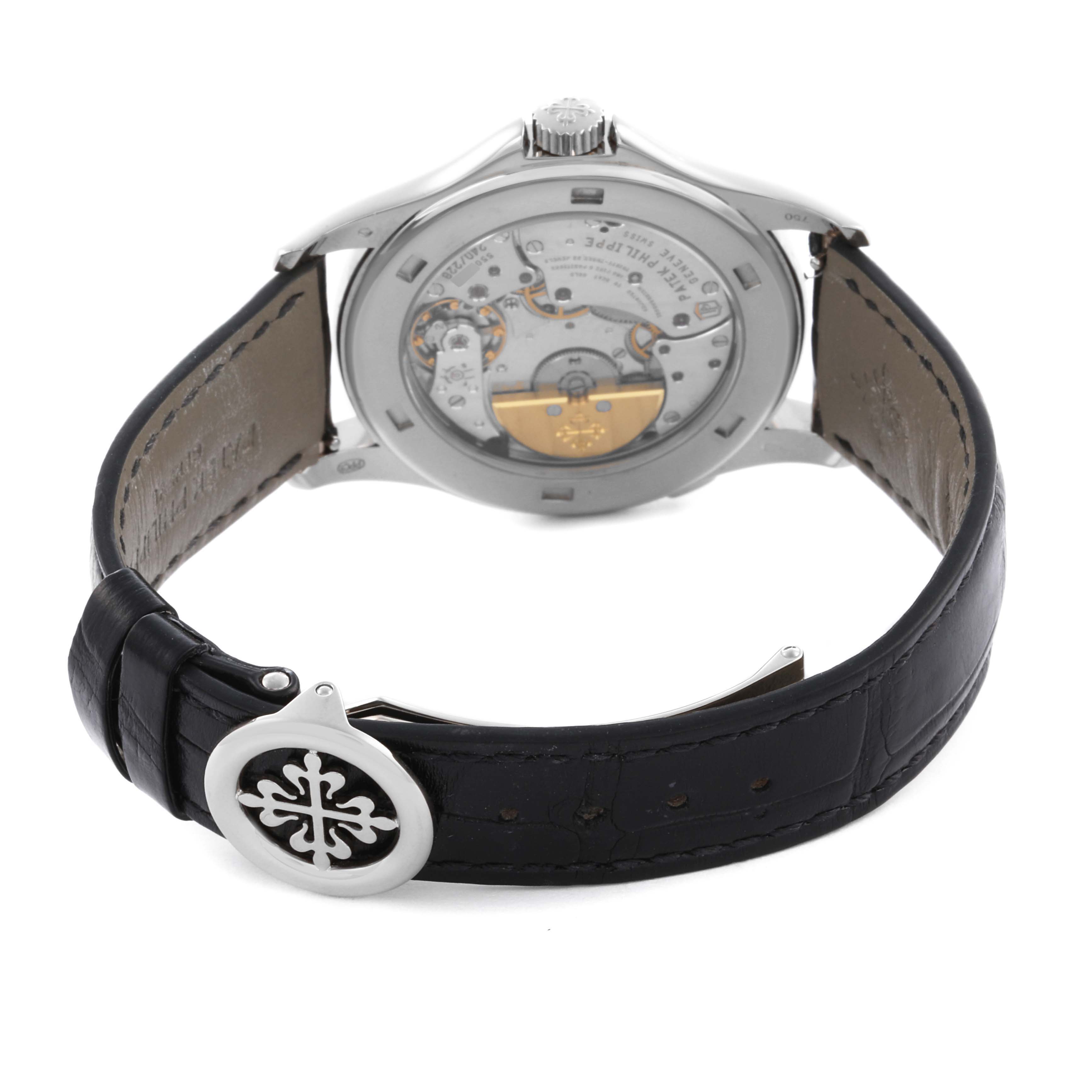 The image shows the back of a Patek Philippe Complications 5130G Men
s White Gold Silver Dial 5130G Men
s White Gold Silver Dial watch, highlighting its movement and black leather strap.