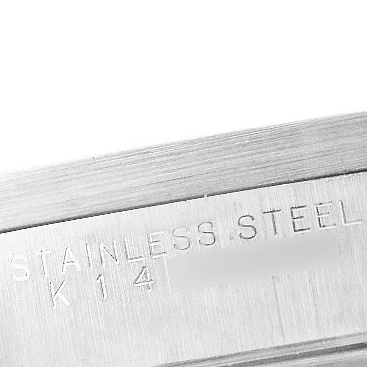 This close-up image shows the side of the case for the Rolex Air-King 14010 Men's Stainless Steel Blue Dial 14010 Men's Stainless Steel Blue Dial model, featuring the "STAINLESS STEEL" engraving.