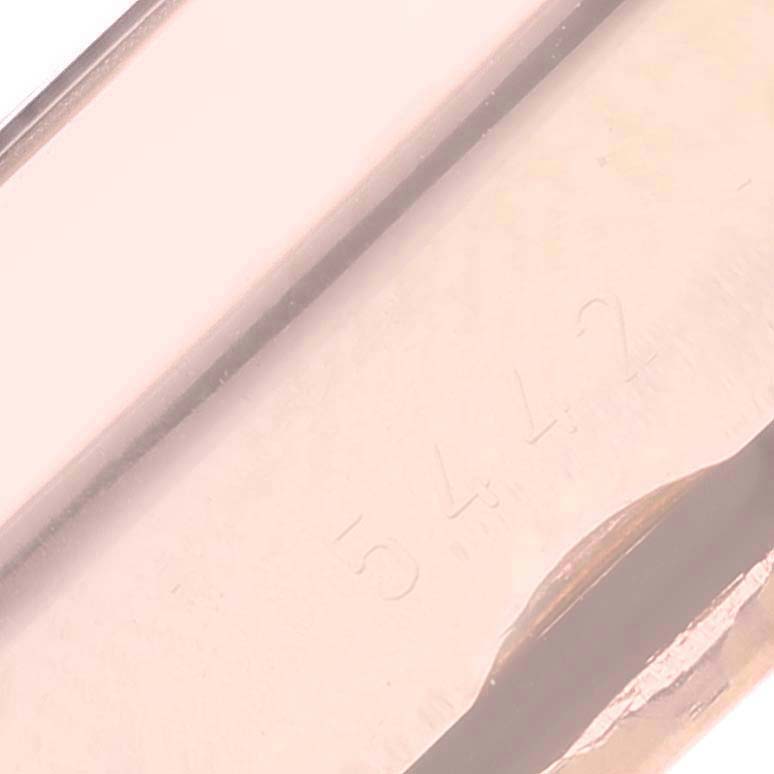 This image shows a close-up angle of the engraved serial number on the side of a Rolex Cellini 5442 Men's Rose Gold Black Dial 5442 Men's Rose Gold Black Dial watch.