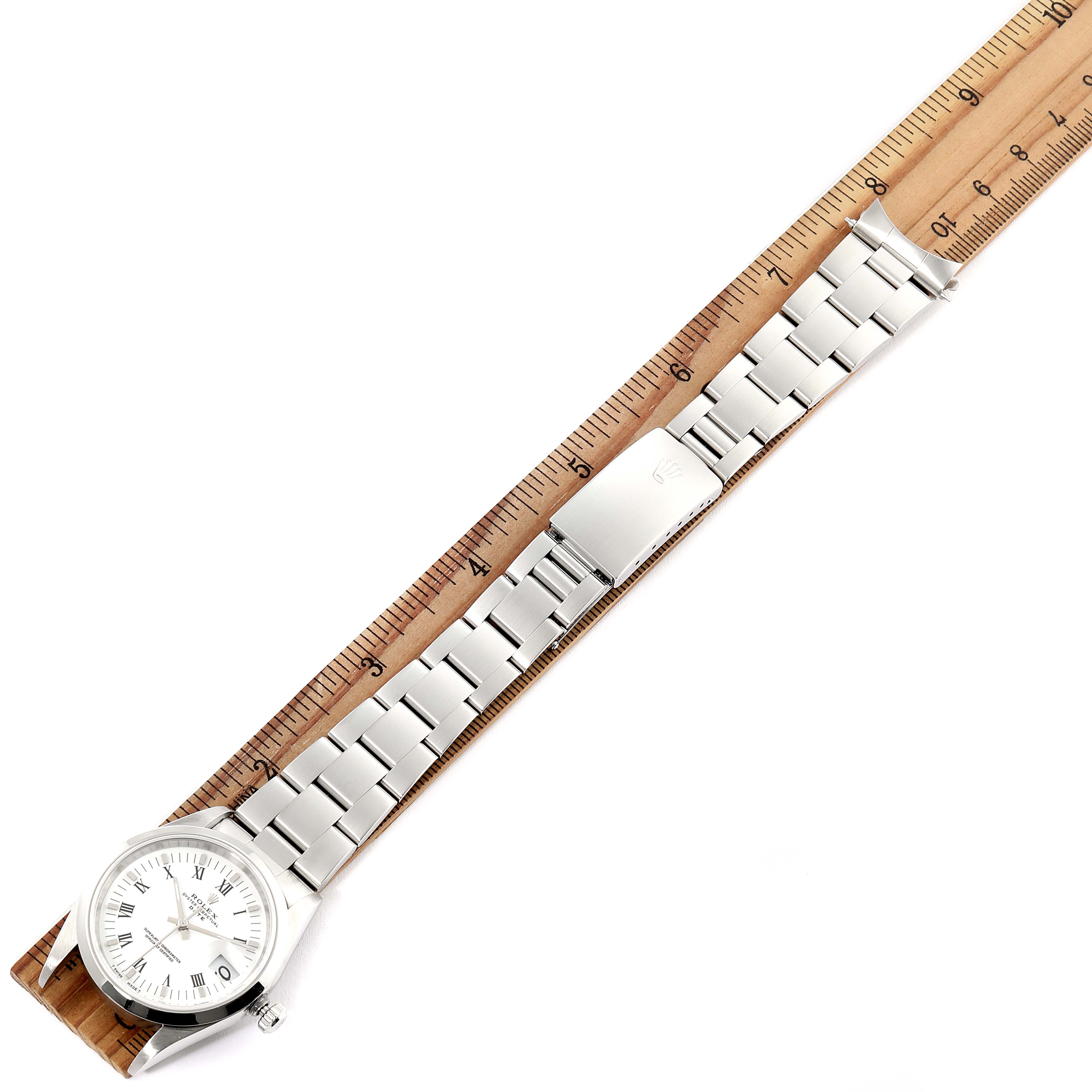 This image shows the full length of a Rolex Date 15200 Men's Stainless Steel White Dial 15200 Men's Stainless Steel White Dial model watch, including the face, bracelet, and clasp, laid against a ruler.