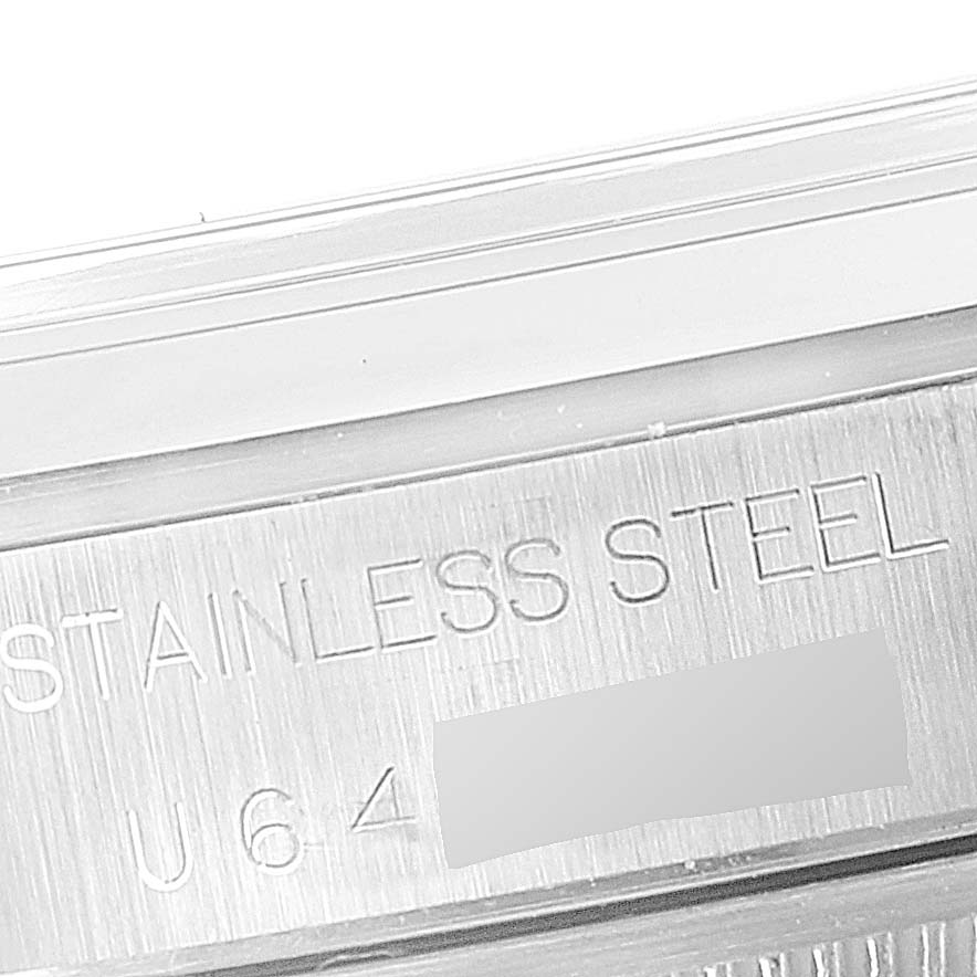 This image shows a close-up of the engravings on the stainless steel case of a Rolex Date 15200 Men's Stainless Steel White Dial 15200 Men's Stainless Steel White Dial model watch.