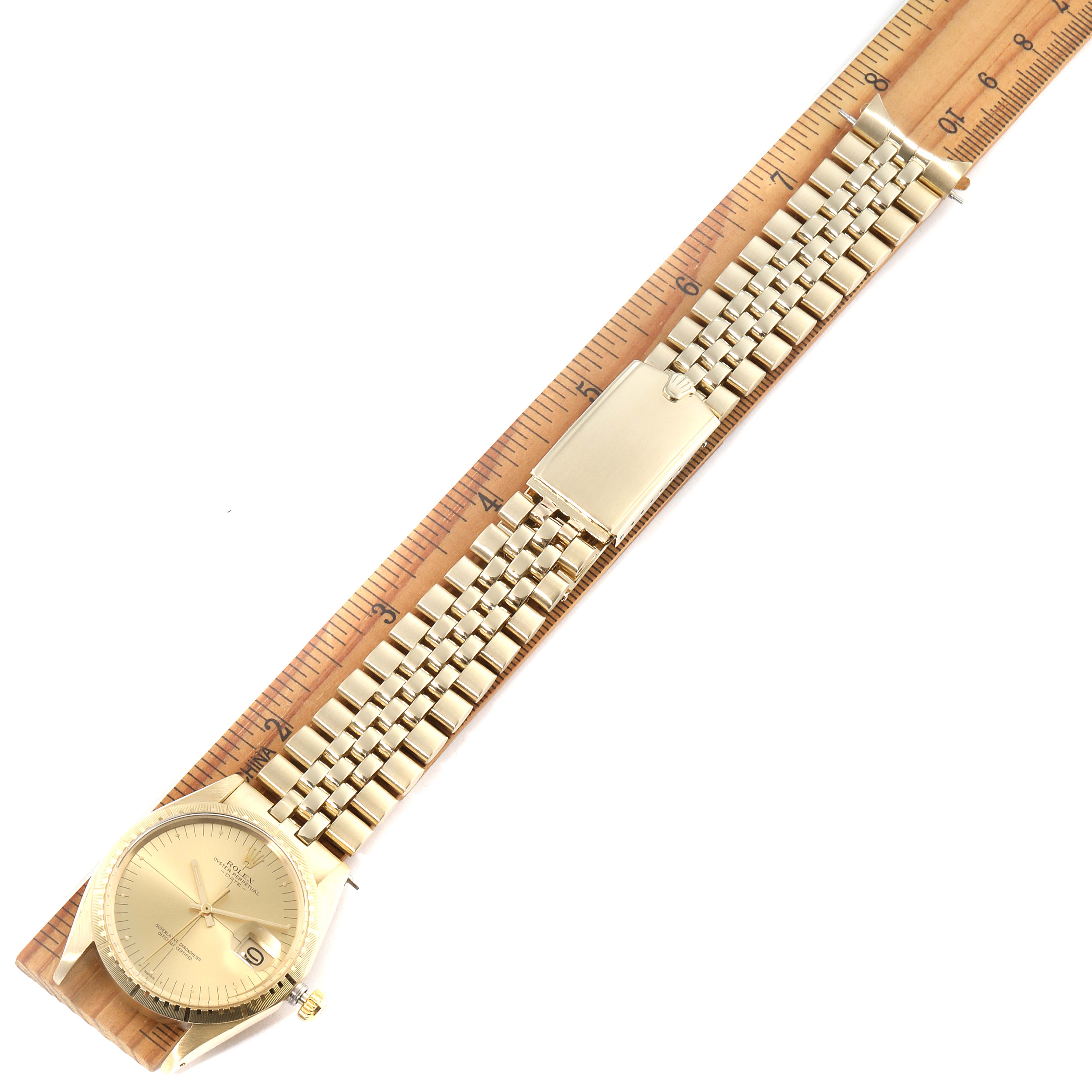 The Vintage Collection watch by Rolex is shown from above, displaying its face, bracelet, and clasp against a ruler for size reference.