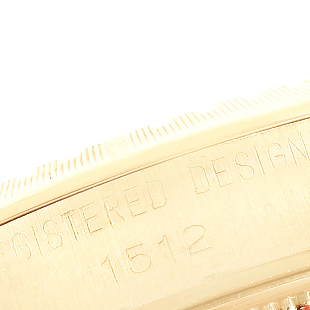 The image shows a close-up of the bezel and engraved text on the side of a Rolex Vintage Collection 1512 Men's Yellow Gold Champagne Dial 1512 Men's Yellow Gold Champagne Dial watch.