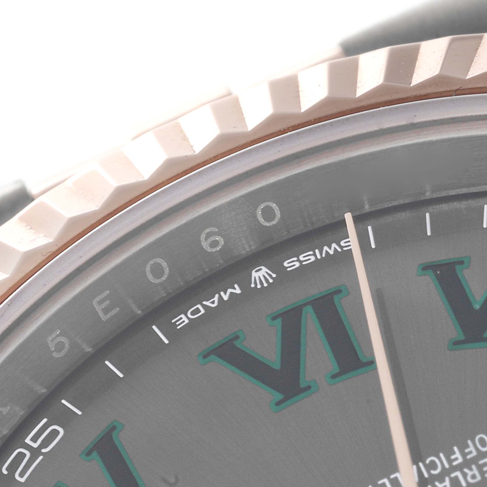 This close-up angle of the Rolex Datejust 41 126331 Men
s Steel and Gold (two tone) Grey Dial 126331 Men
s Steel and Gold (two tone) Grey Dial shows the fluted bezel, part of the dial, and the Rolex logo with "SWISS MADE."