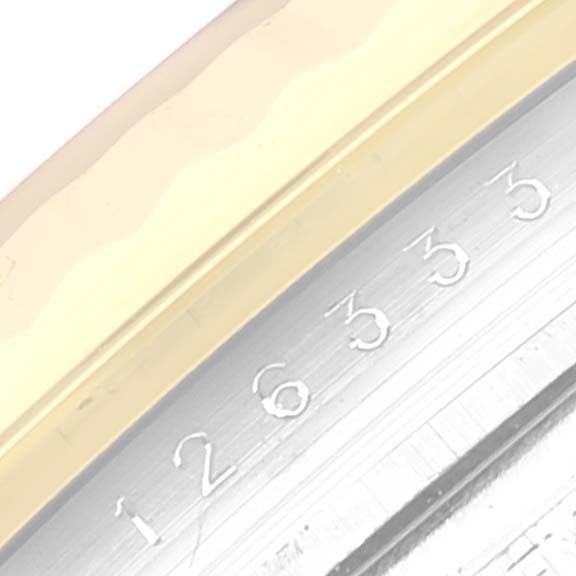 This close-up image shows the serial number engraved on the metal case of a Rolex Datejust 41 126333 Men's Steel and Gold (two tone) Champagne Dial 126333 Men's Steel and Gold (two tone) Champagne Dial watch.