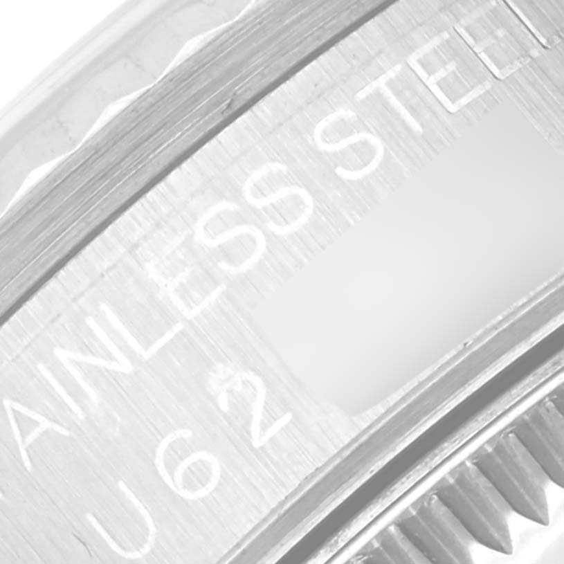 The image shows a close-up of a stainless steel bezel and crown detail on a Rolex Mid-Size 68274 Women
s Stainless Steel Blue Dial model.