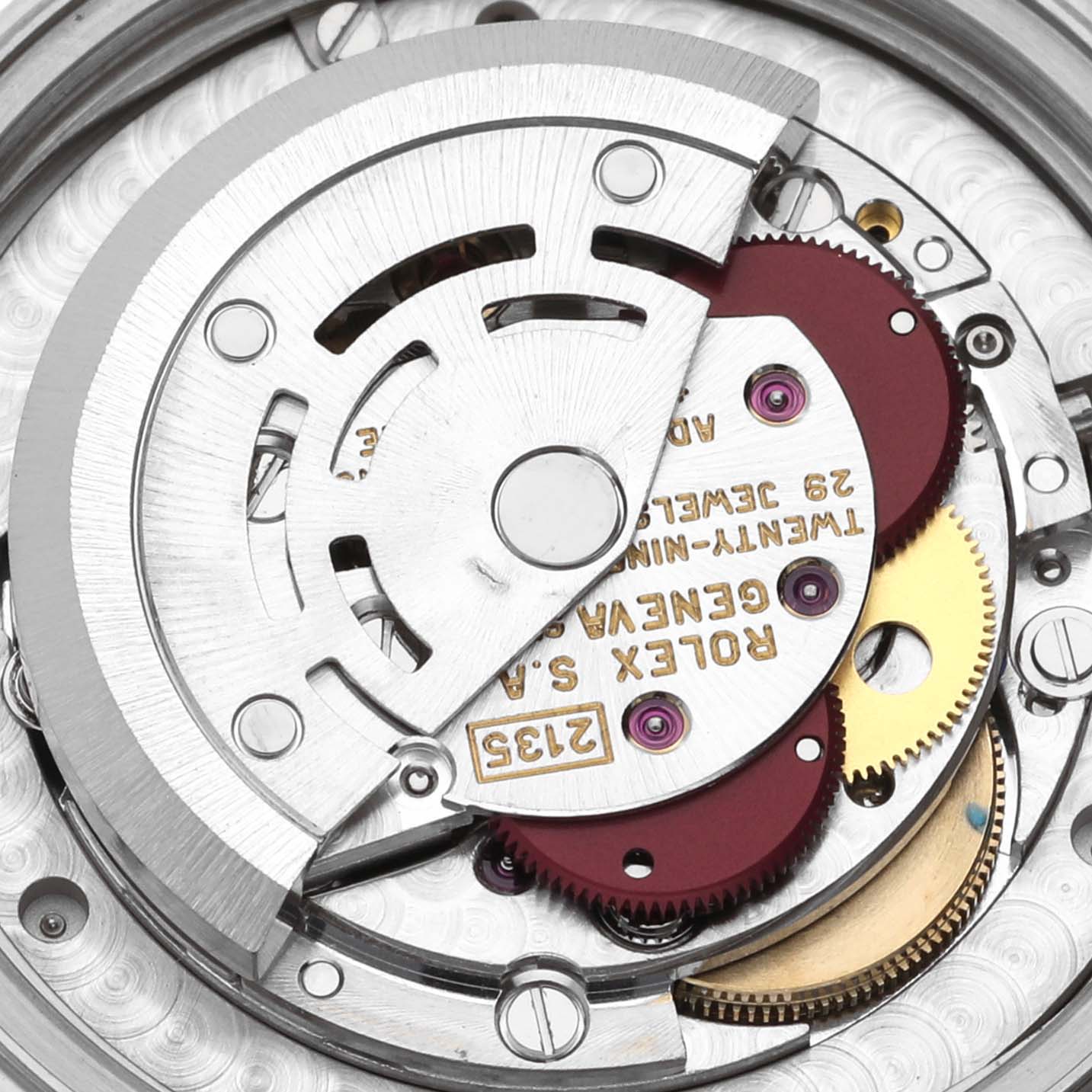The image shows the movement mechanism of a mid-size Rolex watch, featuring gears, a rotor, and inscriptions.