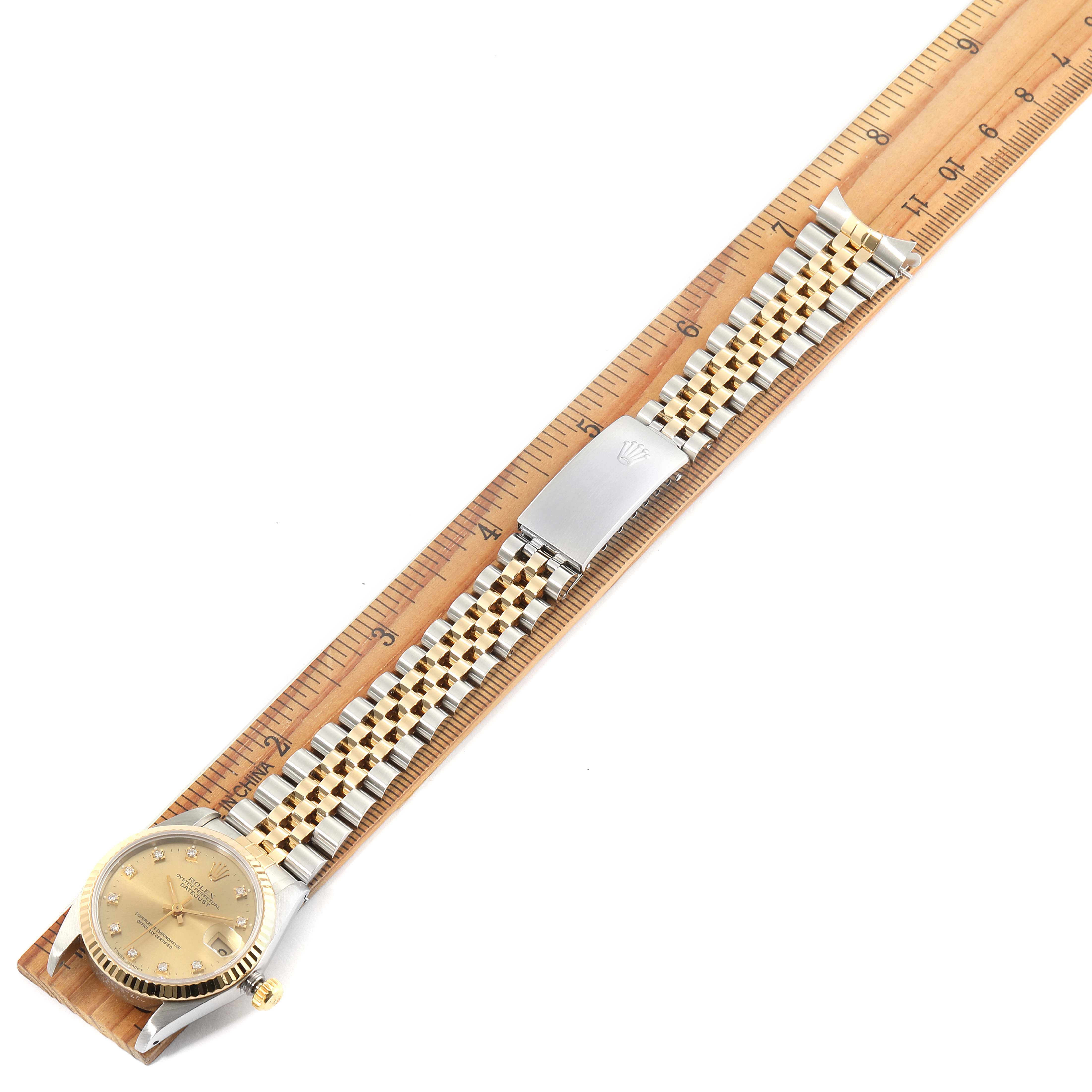 The image shows a Rolex Mid-Size 68273 Women's Steel and Gold (two tone) Champagne Dial 68273 Women's Steel and Gold (two tone) Champagne Dial watch laid flat with its full bracelet and clasp, alongside a ruler for scale.