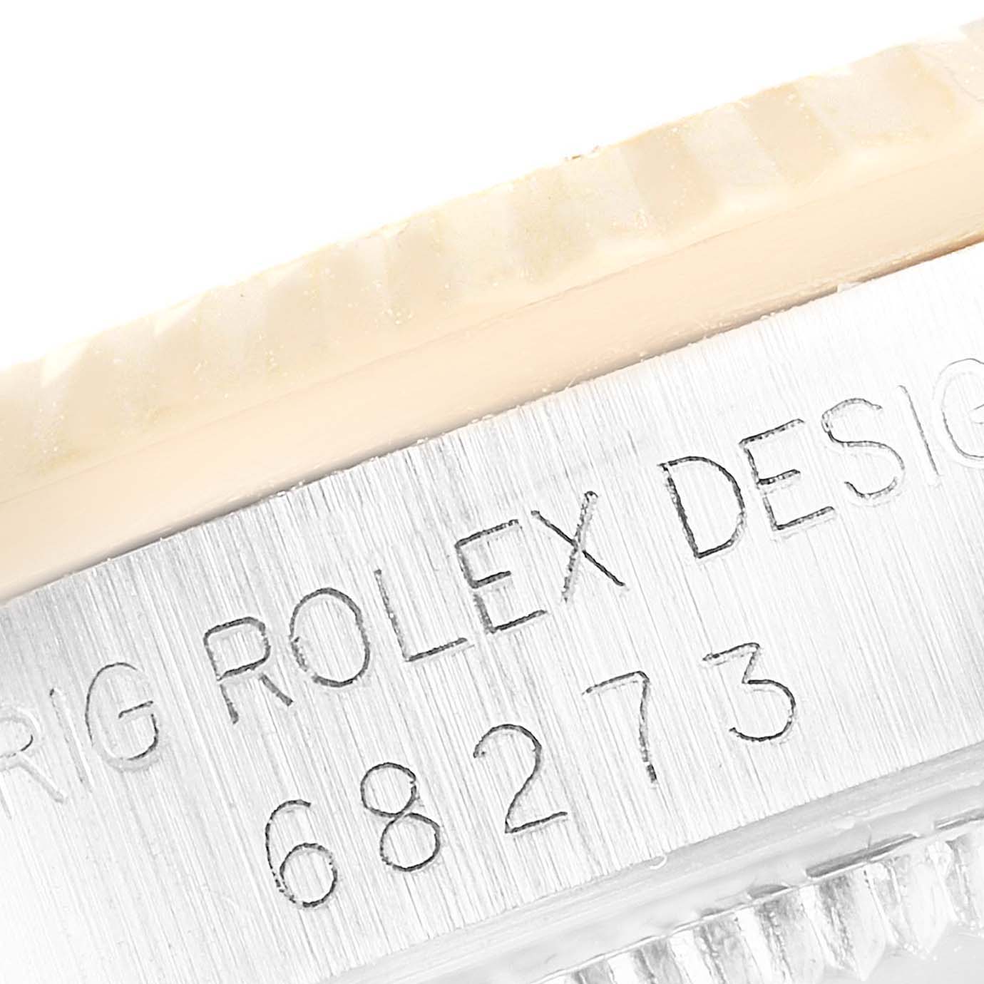 This close-up image shows the engraved model number and design details on the side of a Rolex Mid-Size 68273 Women's Steel and Gold (two tone) Champagne Dial 68273 Women's Steel and Gold (two tone) Champagne Dial watch case.