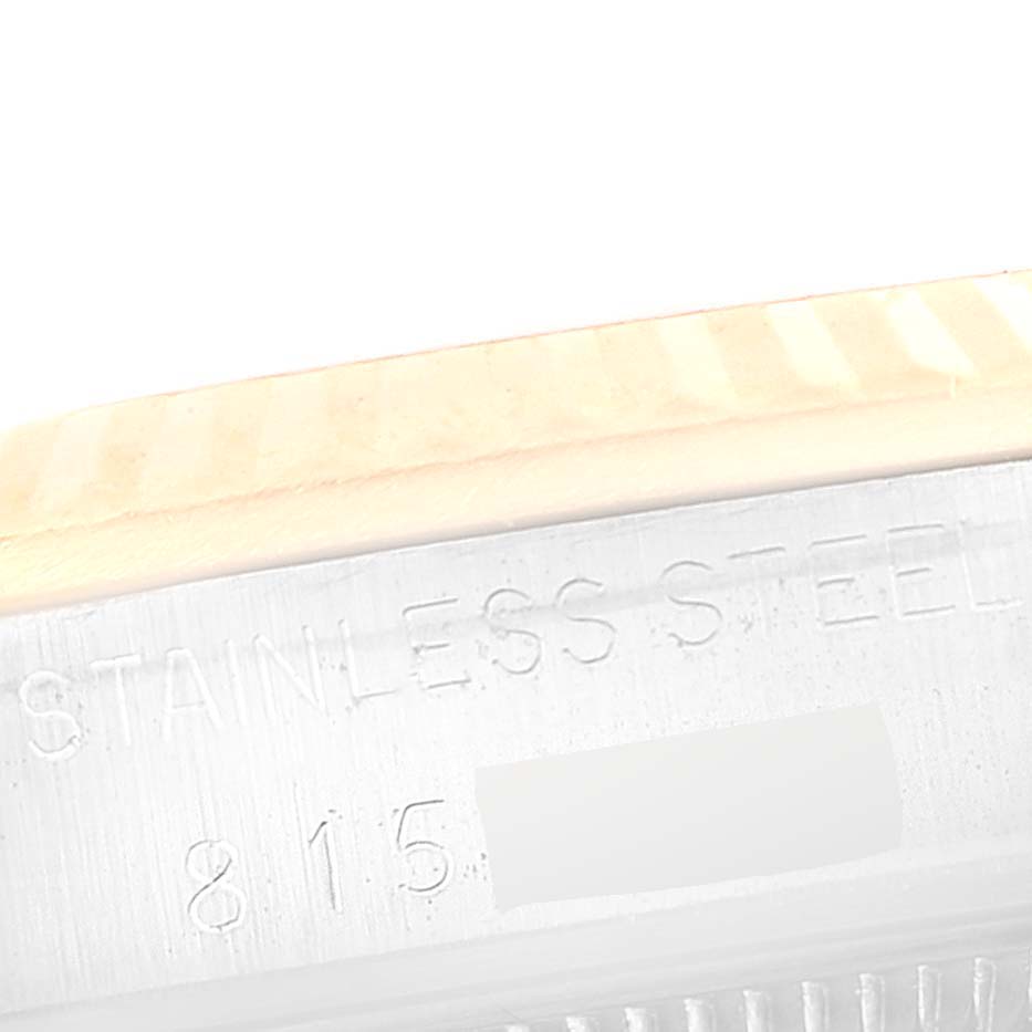 This image shows a close-up of the side engraving on the bezel and case of a Rolex Mid-Size 68273 Women's Steel and Gold (two tone) Champagne Dial 68273 Women's Steel and Gold (two tone) Champagne Dial watch, indicating "STAINLESS STEEL" and a partial serial number.