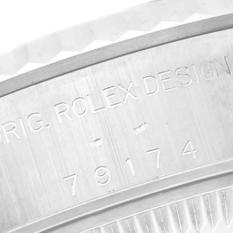 The close-up image shows the engraved serial number on the case of a Rolex Datejust 79174 Women's Stainless Steel Silver Dial 79174 Women's Stainless Steel Silver Dial.
