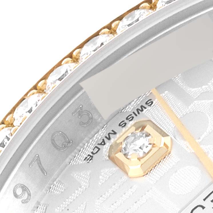This close-up image of a Rolex Datejust 116243 Men's Stainless Steel Silver Dial 116243 Men's Stainless Steel Silver Dial watch shows a portion of the bezel and dial featuring a diamond marker and "Swiss Made" text.